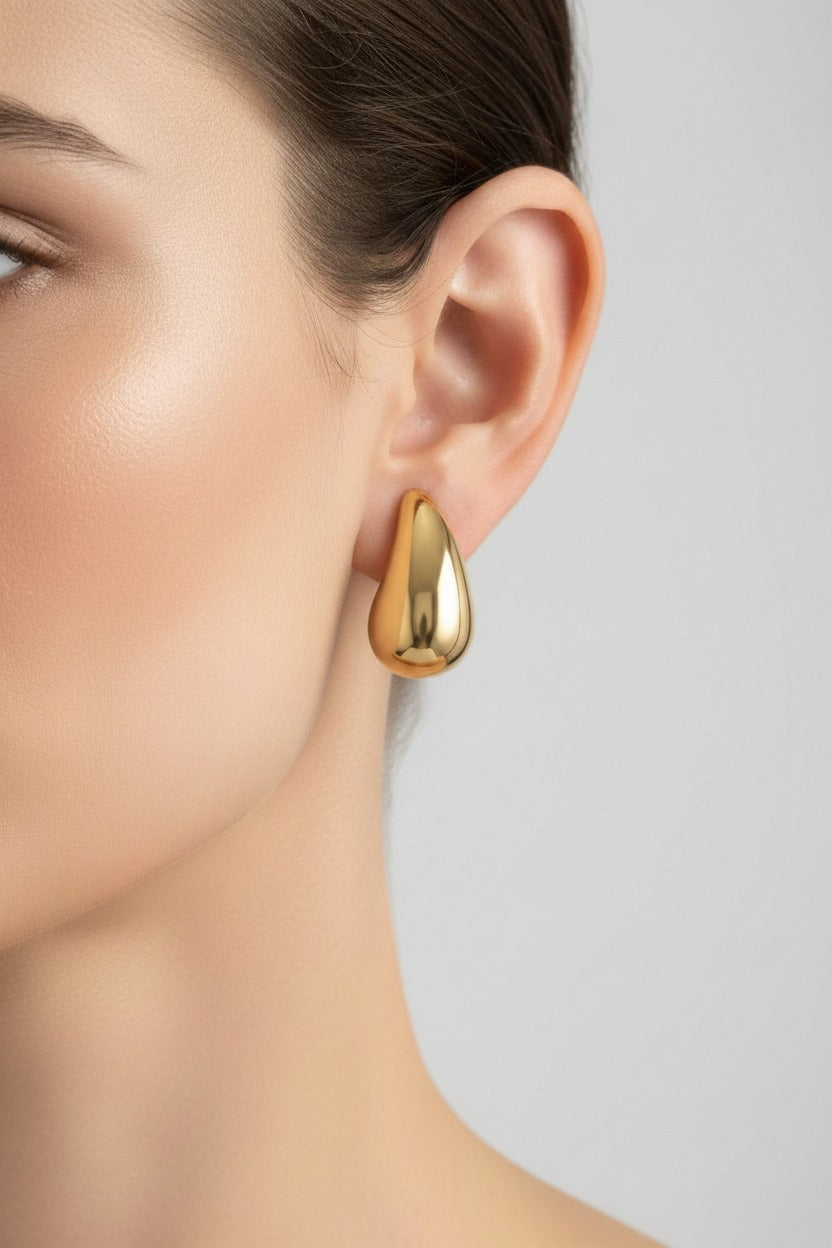 Gold teardrop stud earrings crafted from stainless steel with 18K PVD gold plating, featuring a smooth polished teardrop silhouette