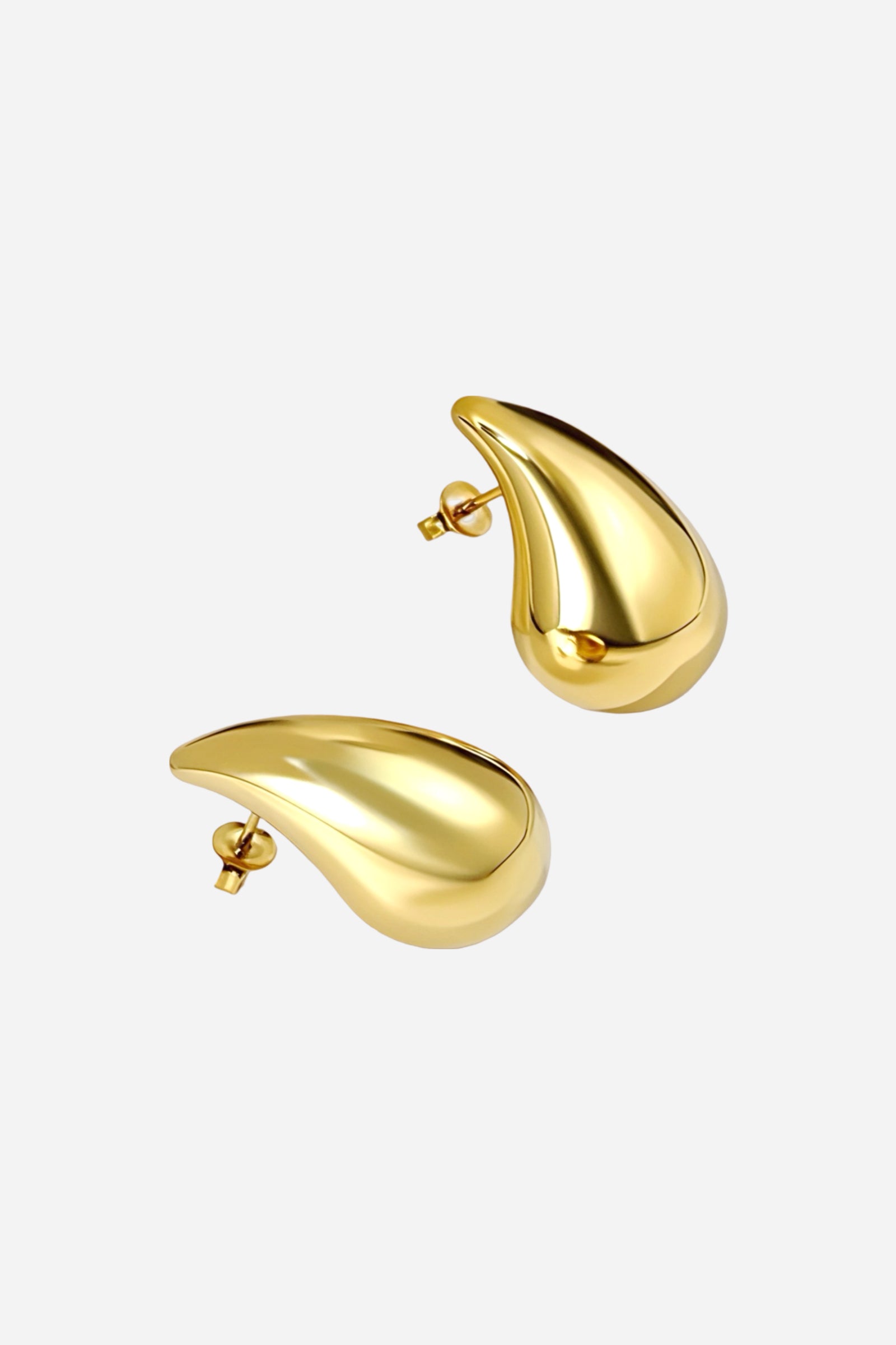 Angled view of gold teardrop stud earrings made from stainless steel with a sleek PVD 18K gold plated finish, highlighting their sculpted droplet form and glossy mirror polish – GLISTIA.