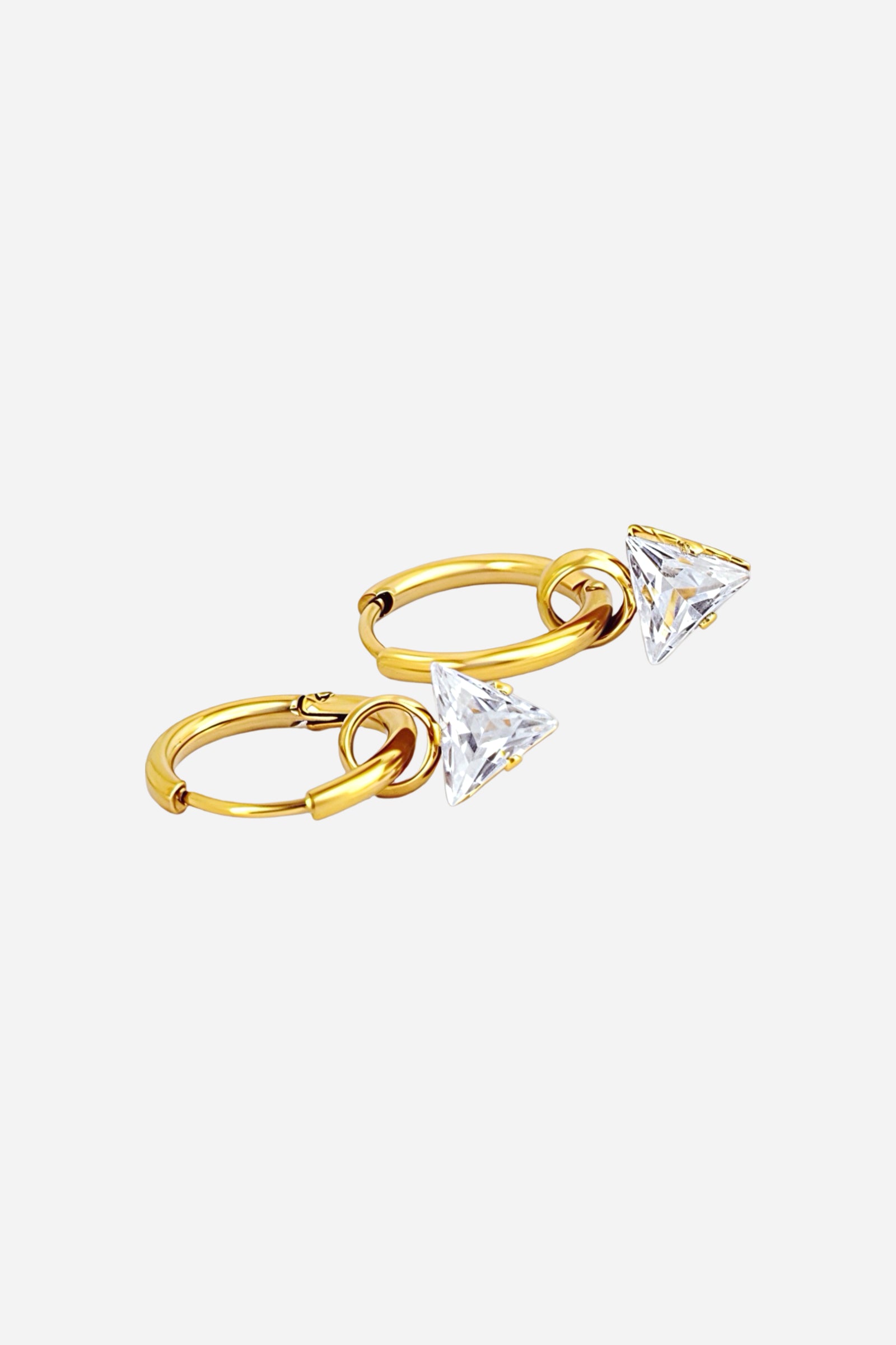 Top view of gold hoop earrings featuring clear triangle-cut crystals suspended from sleek hoops, crafted from stainless steel with a polished PVD 18K gold plating – GLISTIA.