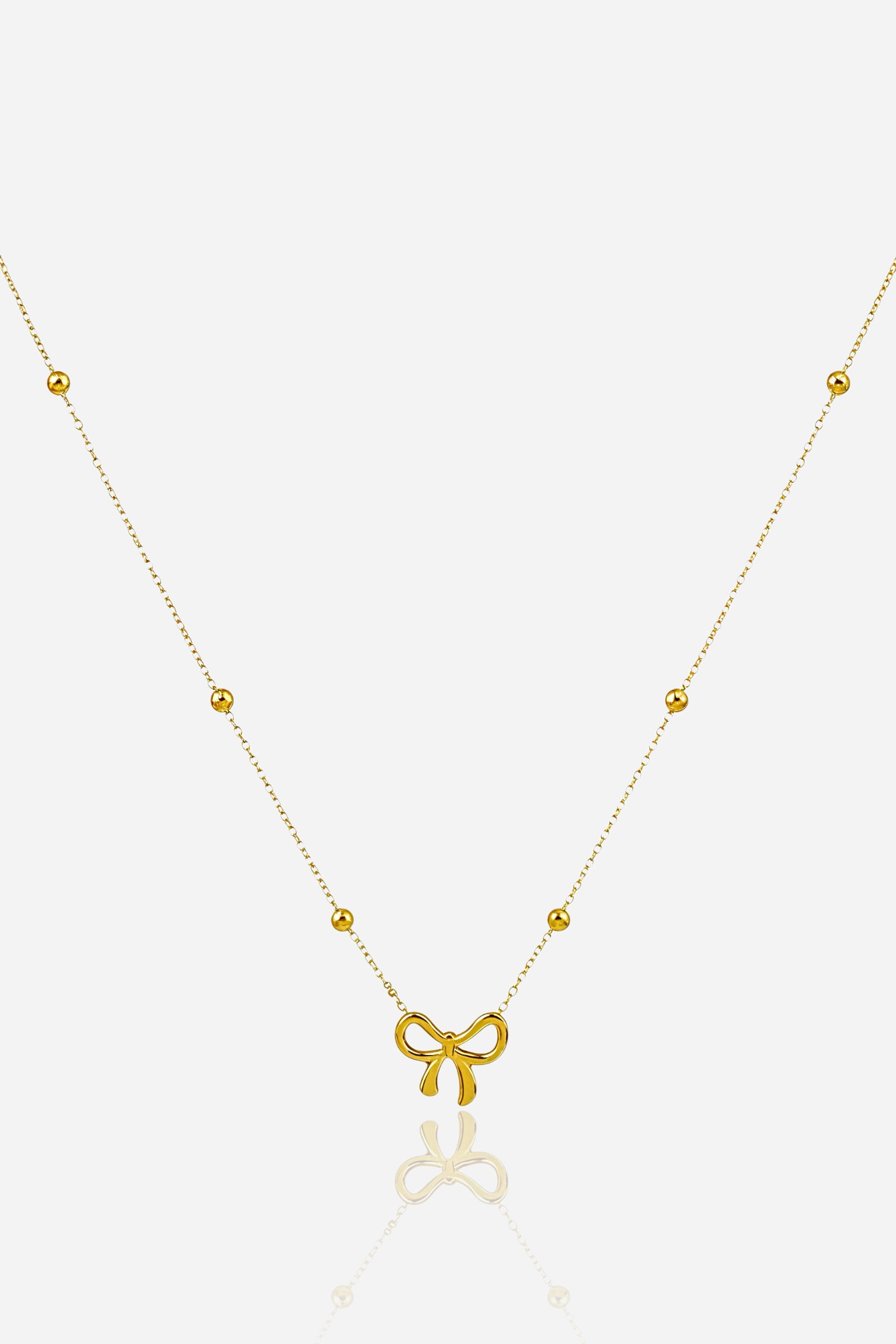 Top view of Golden Bow Necklace with delicate beaded chain – GLISTIA