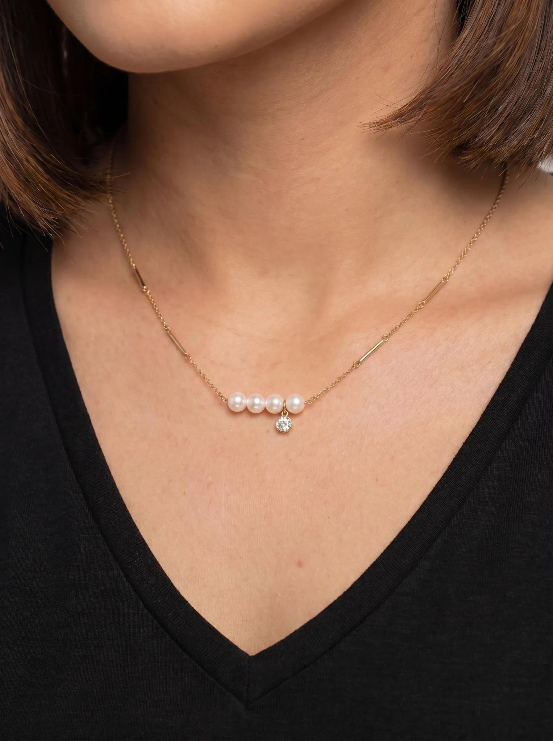 Golden Pearl Bar Necklace featuring a row of white pearls with a delicate crystal charm on an 18K gold plated chain by GLISTIA.