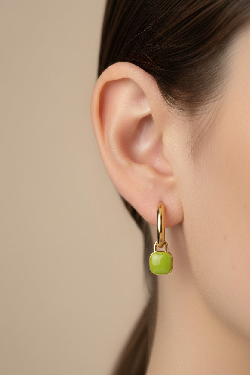 Green charm drop hoop earrings in 18K PVD gold plated stainless steel worn on ear, minimalist everyday jewellery
