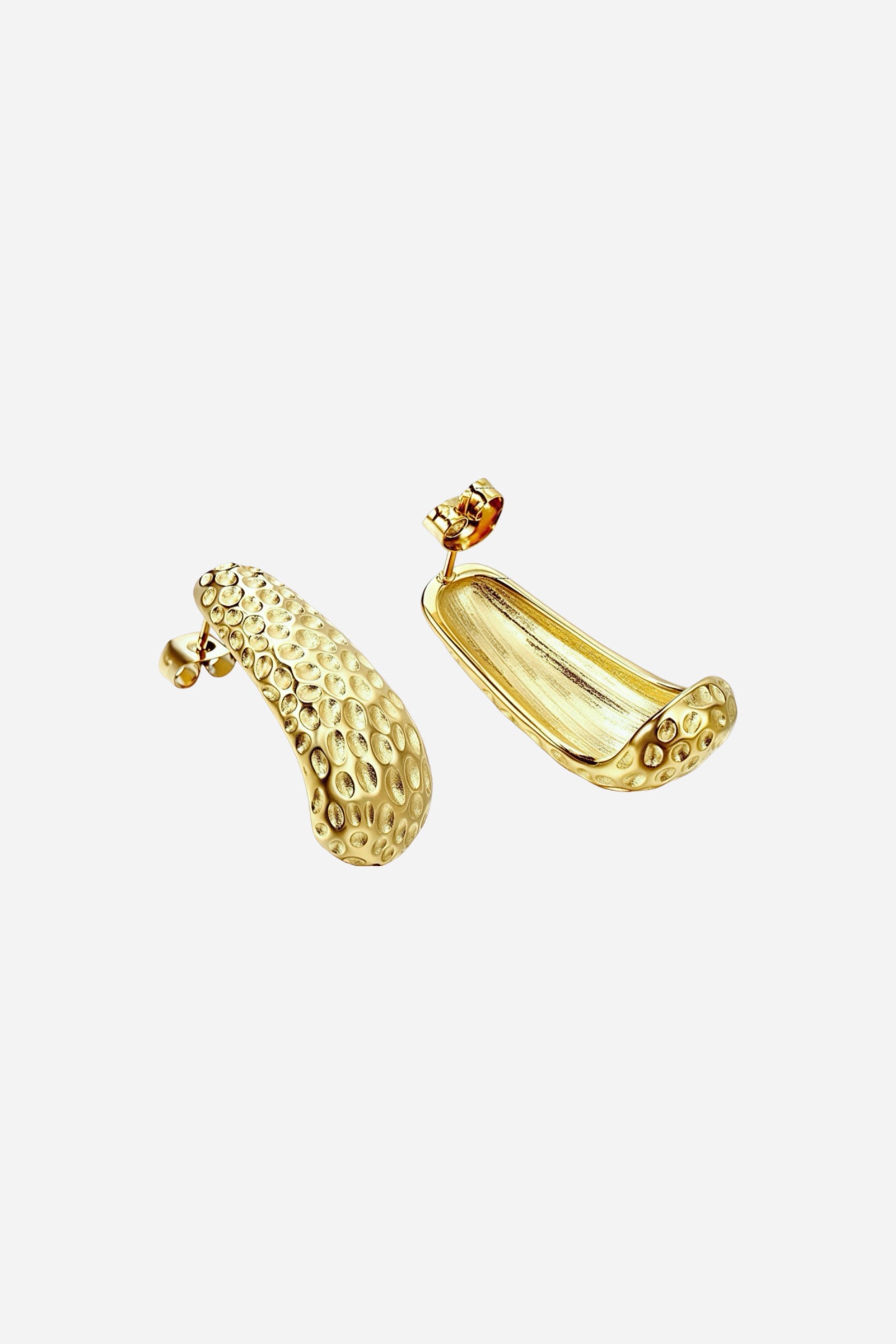 Side view of hammered gold curved stud earrings made from stainless steel with a PVD 18K gold plated finish, highlighting the textured dome surface and smooth inner curve – GLISTIA.