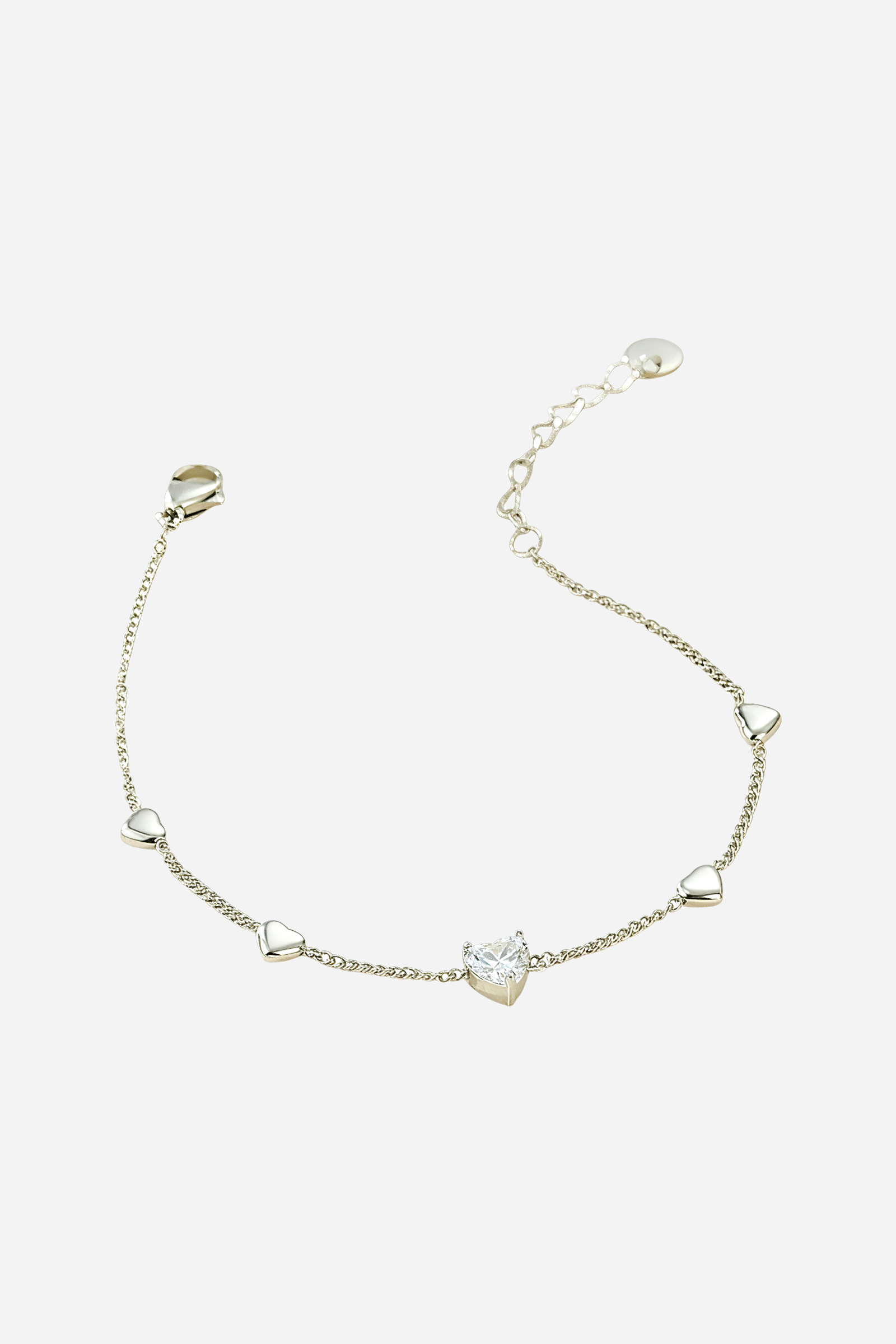 Close-up view of silver Heart Charm Chain Bracelet showing central heart stone and delicate mini hearts by GLISTIA