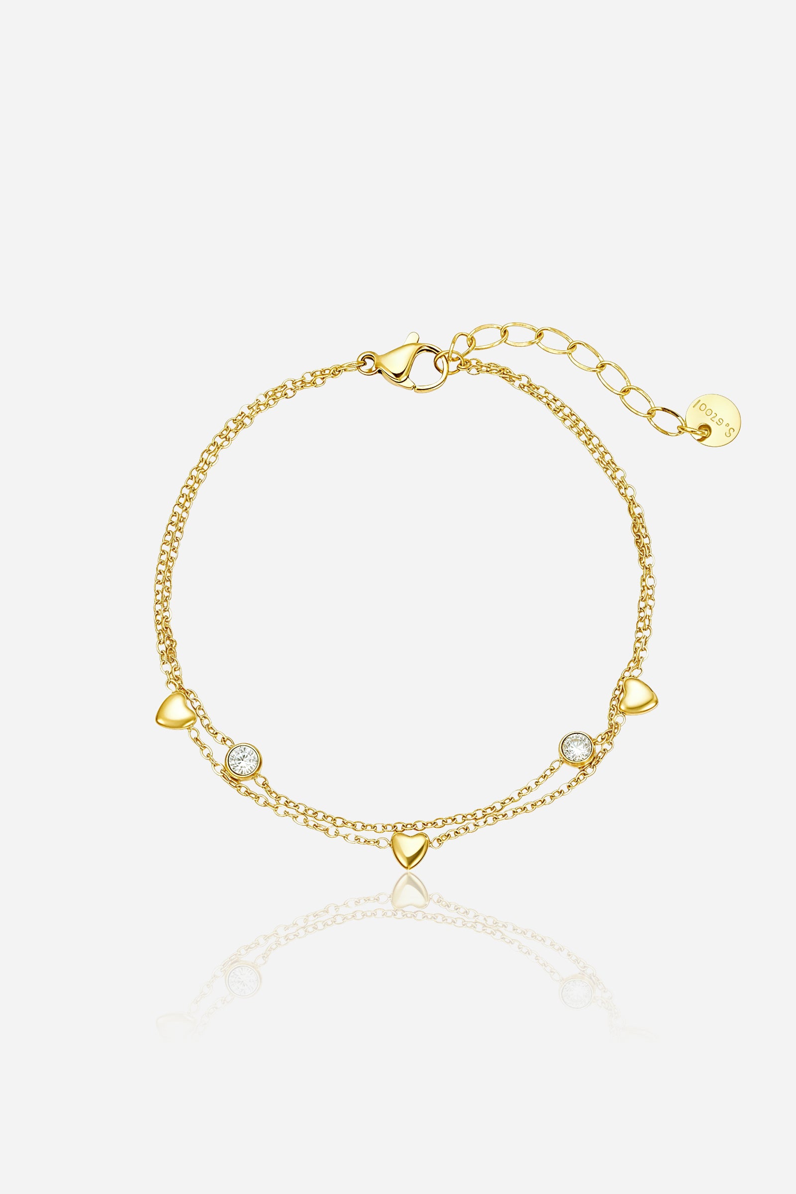 GLISTIA heart duo chain bracelet in PVD 18K gold plated stainless steel shown from the front with polished heart motifs and crystals.