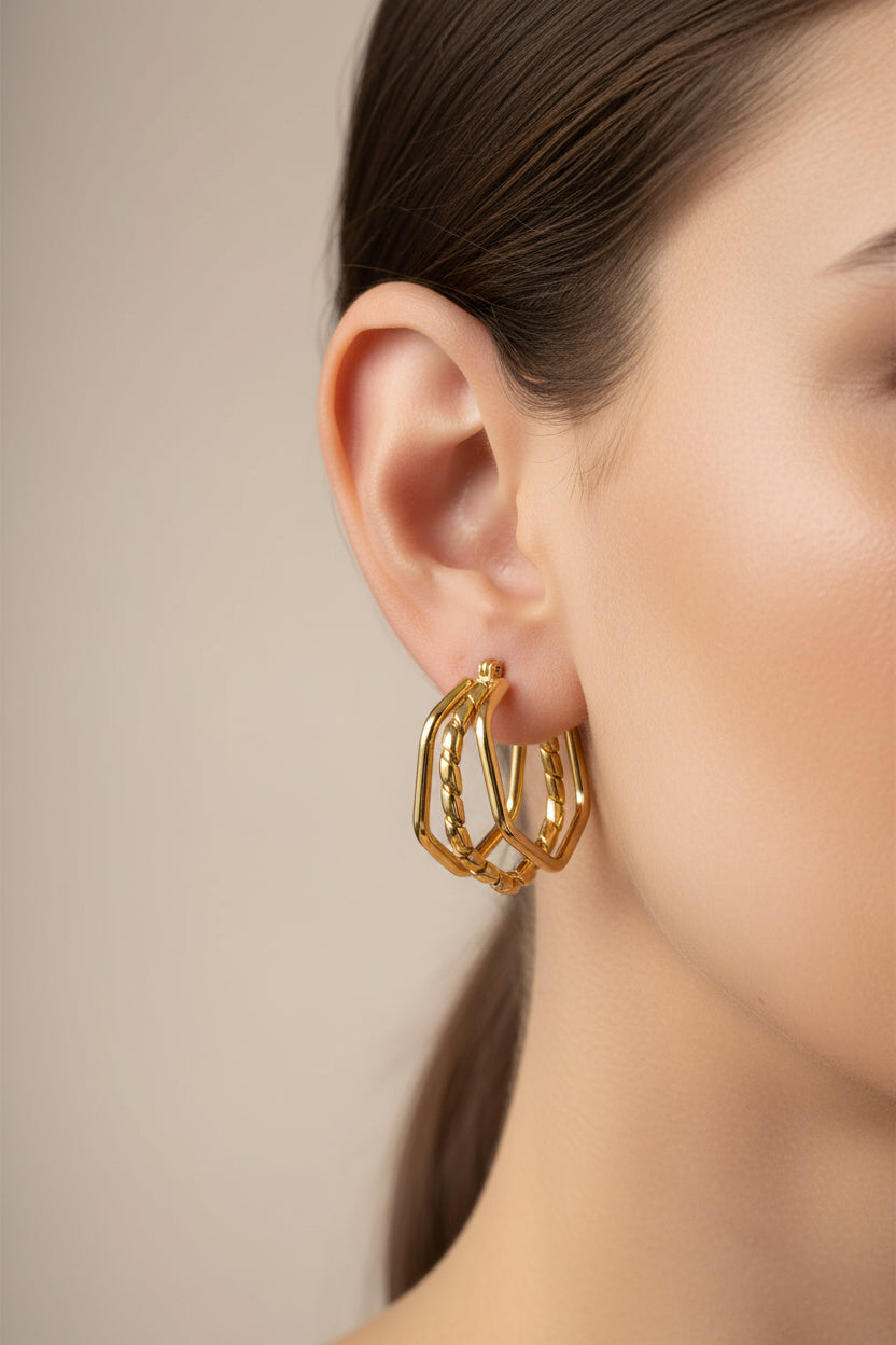 Close-up of hexagon double-layer hoop earrings in 18K PVD gold plated stainless steel, showcasing a chunky geometric silhouette and polished finish