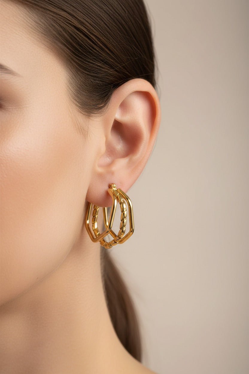 Hexagon double-layer hoop earrings crafted from stainless steel with 18K PVD gold plating, featuring a bold geometric statement design