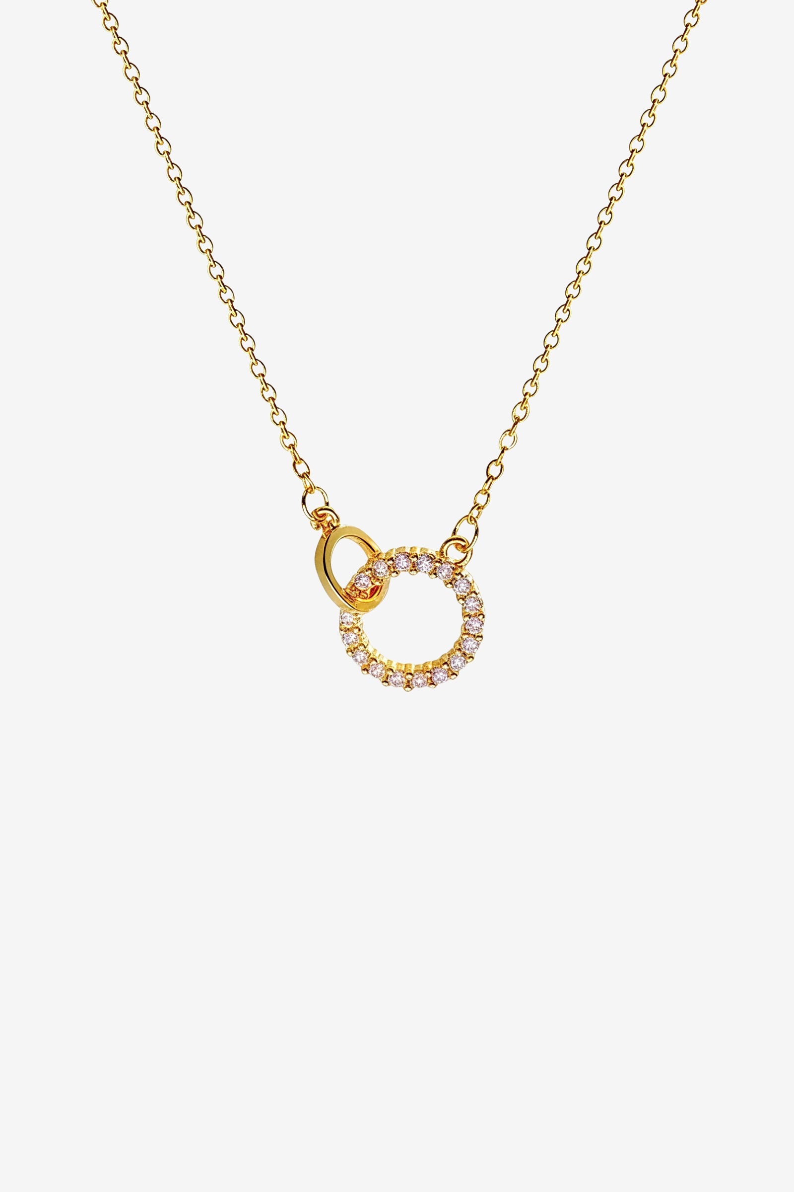 Top view of gold Interlinked Circle Necklace featuring dual rings and crystal detailing – GLISTIA