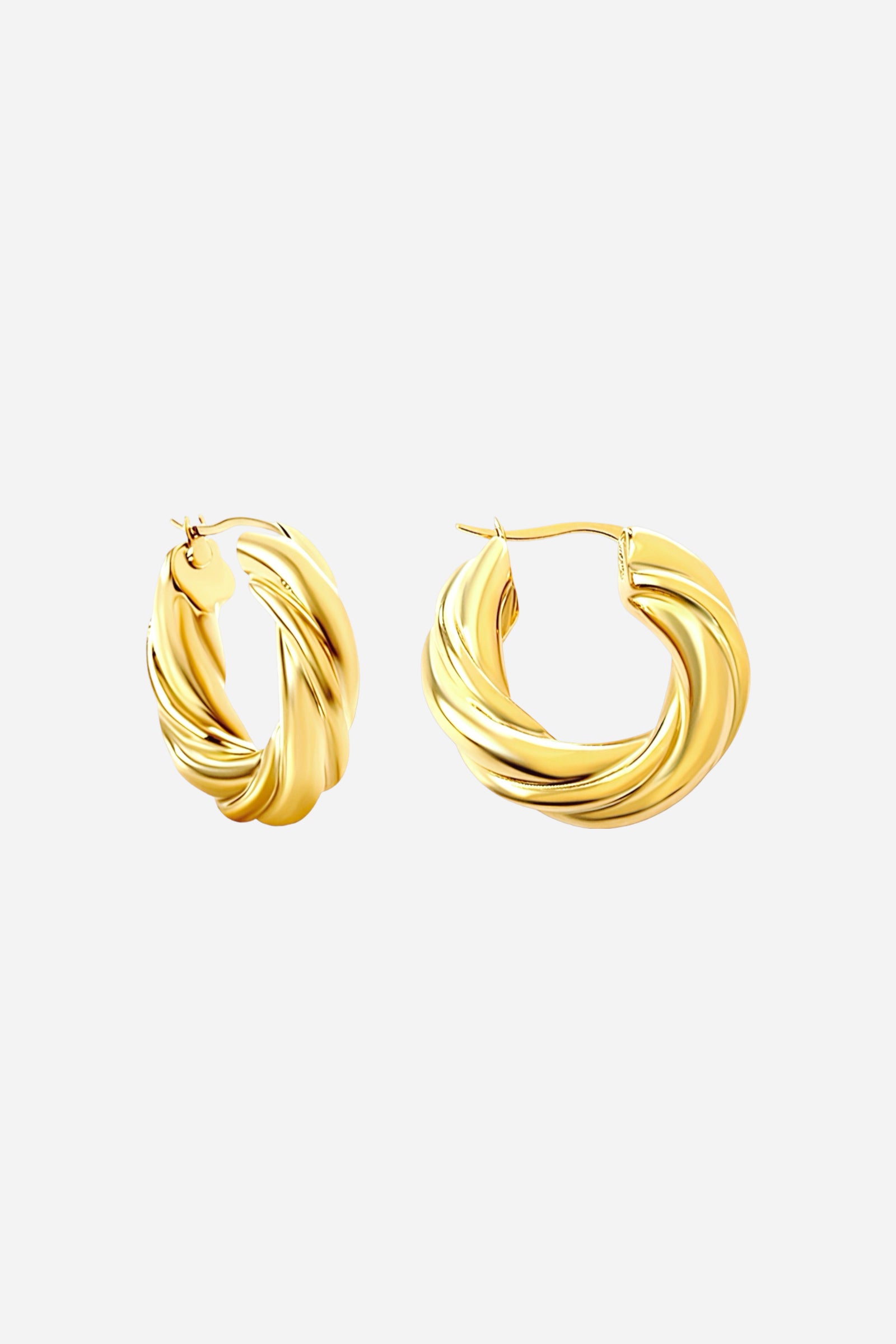 Side view of large twisted gold hoop earrings made from stainless steel with a PVD 18K gold plated finish, featuring a sculptural twisted design and glossy shine — GLISTIA