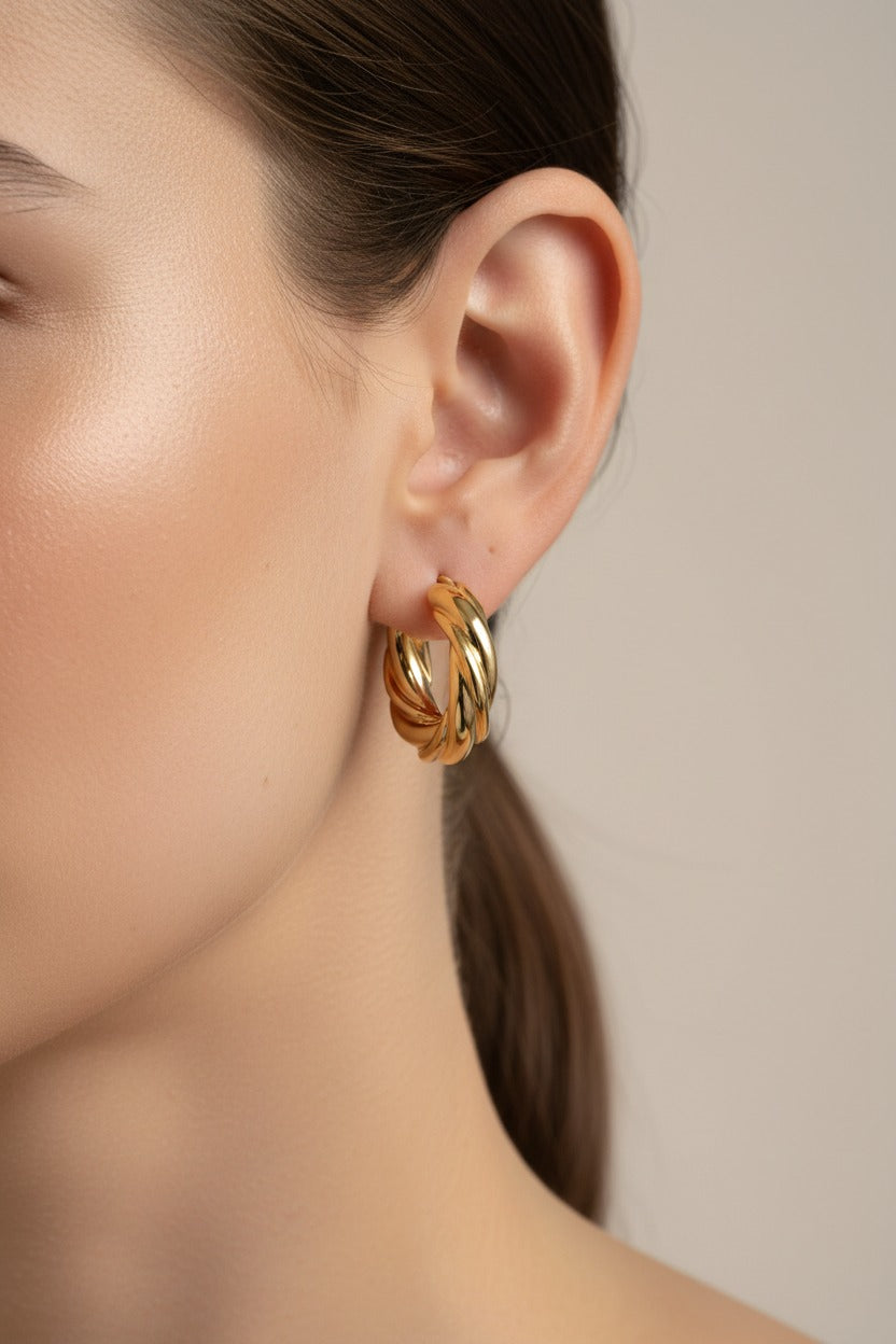 Large twisted gold hoop earrings crafted from stainless steel with 18K PVD gold plating, featuring a bold rope-style design and polished finish