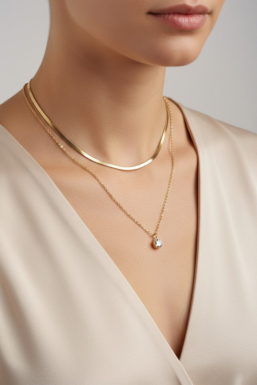 Layered gold chain and crystal necklace in 18K PVD gold plated stainless steel with delicate layered design