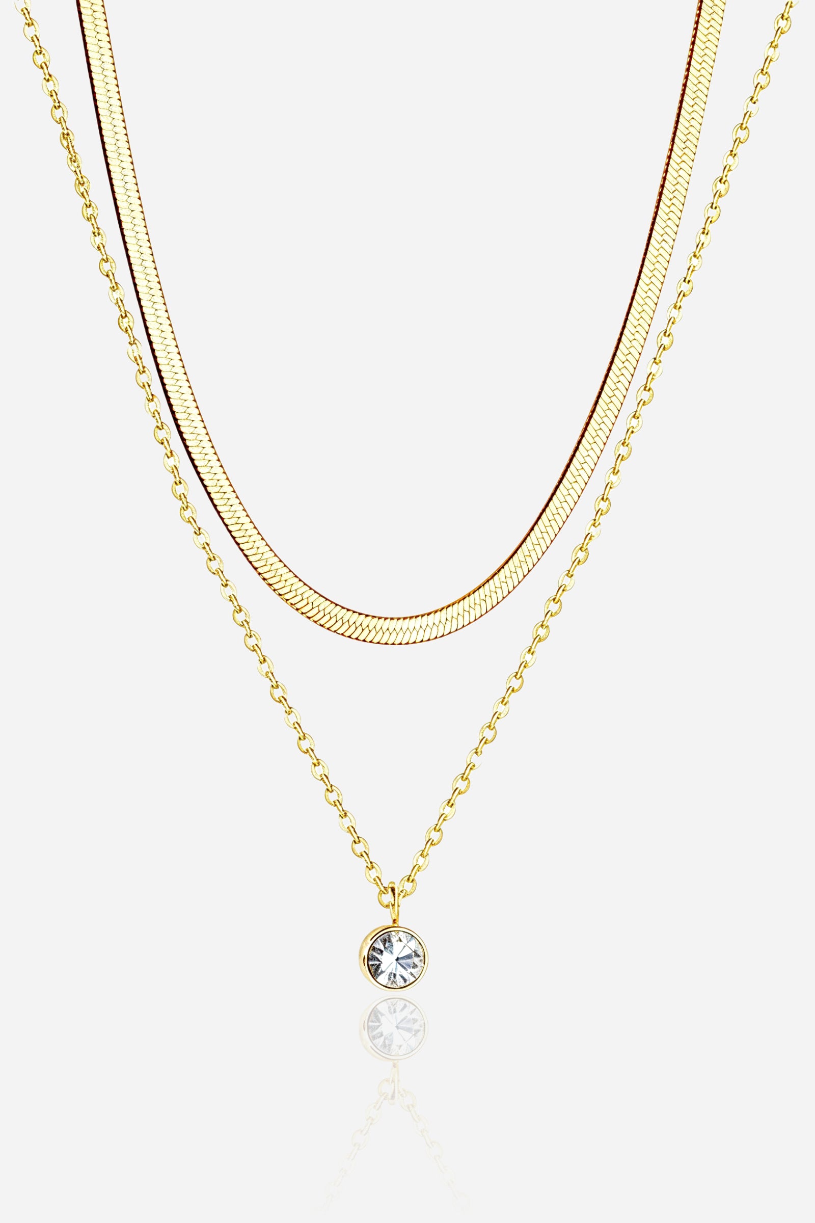 Front view of GLISTIA Layered Gold Chain & Crystal Necklace with snake chain and crystal pendant.