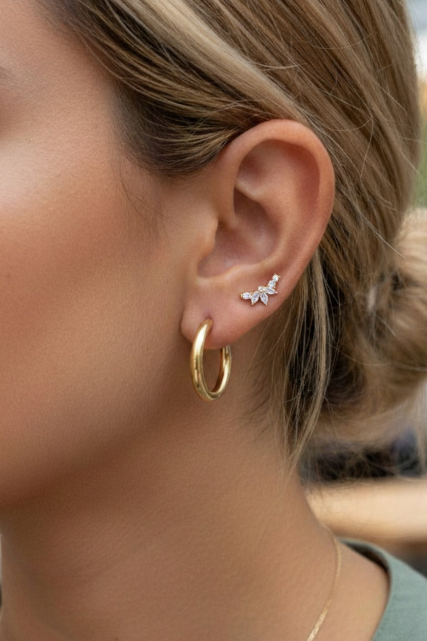 Close-up of marquise cluster stud earrings highlighting marquise-cut and round cubic zirconia stones set in 18K PVD gold plated stainless steel