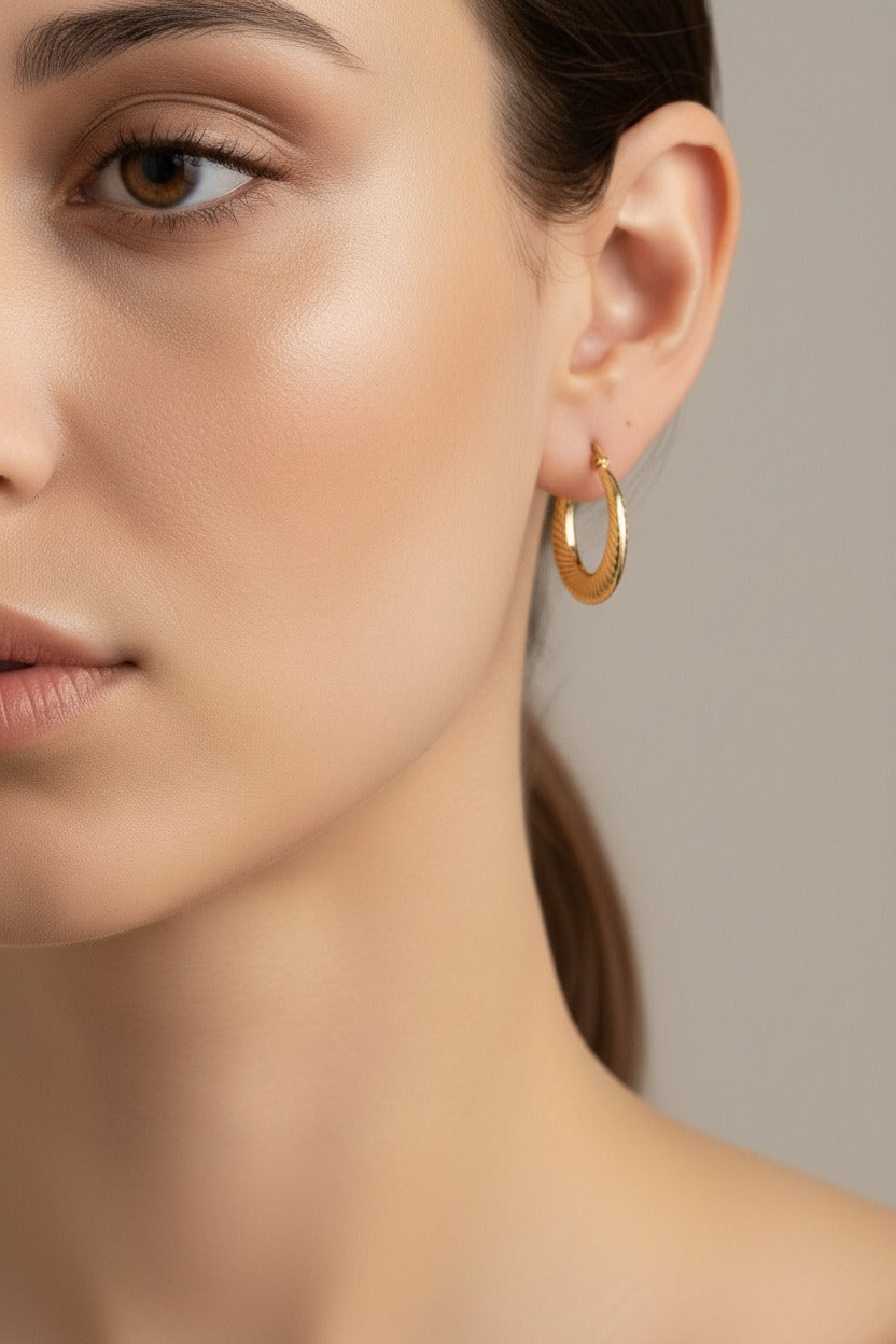 Mini twisted hoop earrings in 18K PVD gold plated stainless steel, lightweight and water safe for everyday wear