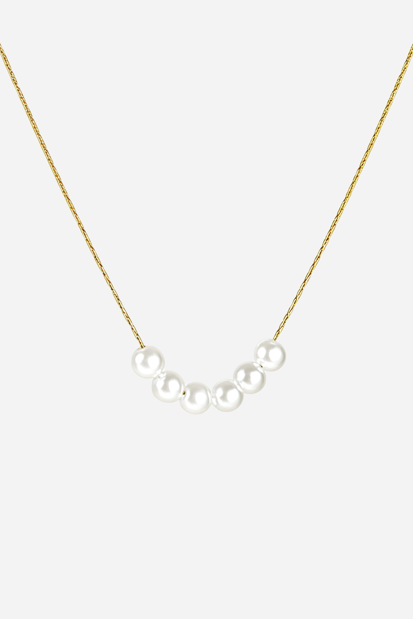 Top view of minimalist pearl bar necklace featuring five glossy pearls on a thin gold chain – GLISTIA.