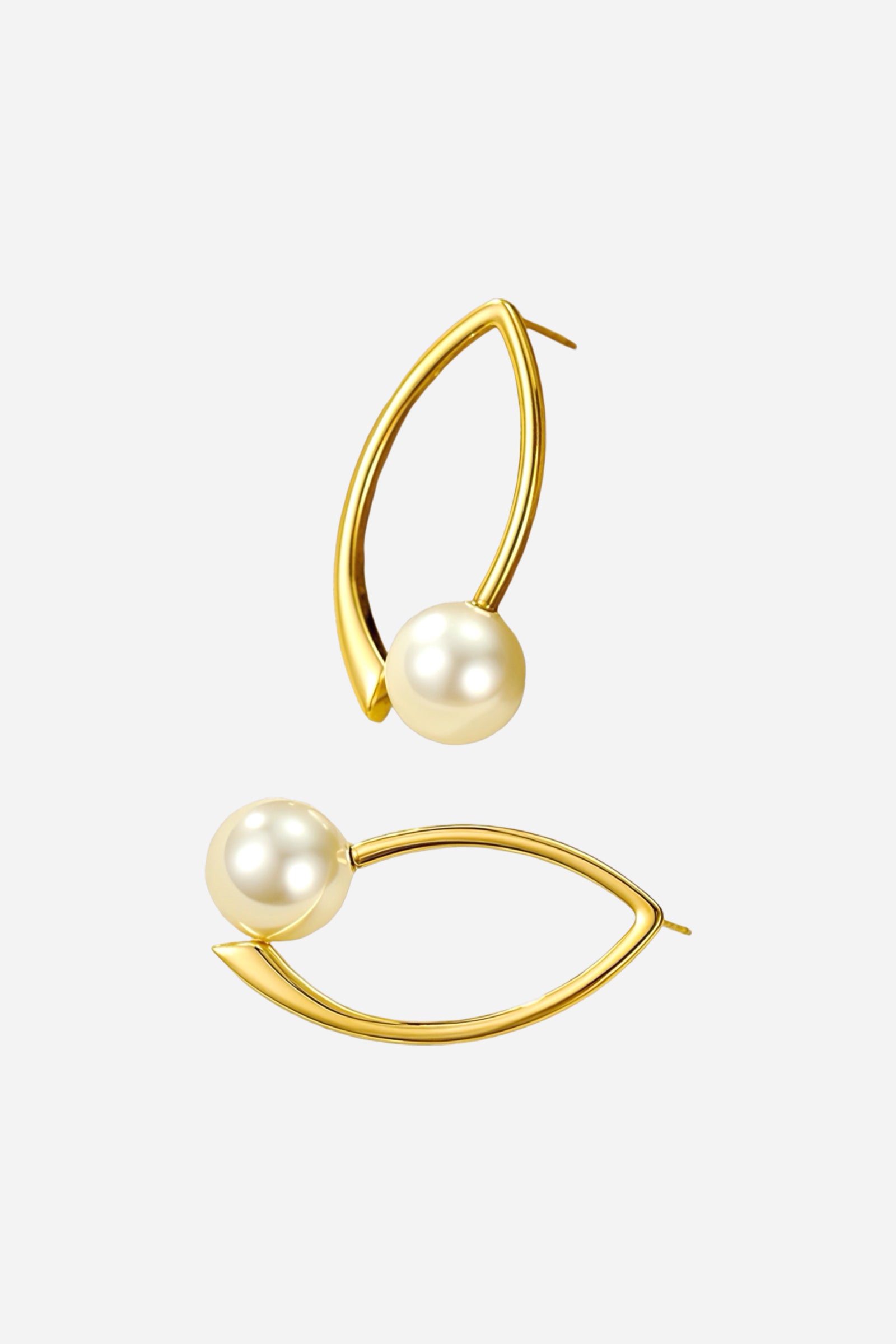 Flat lay view of modern pearl marquise earrings made from stainless steel with PVD 18K gold plated finish, featuring open marquise frame and luminous pearl accents – GLISTIA.