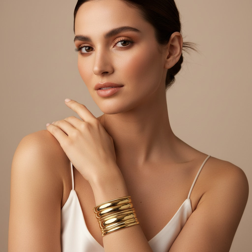 Modern wristwear designed for everyday life, featuring a woman wearing stacked gold bangles with a refined, minimalist style suitable for daily wear