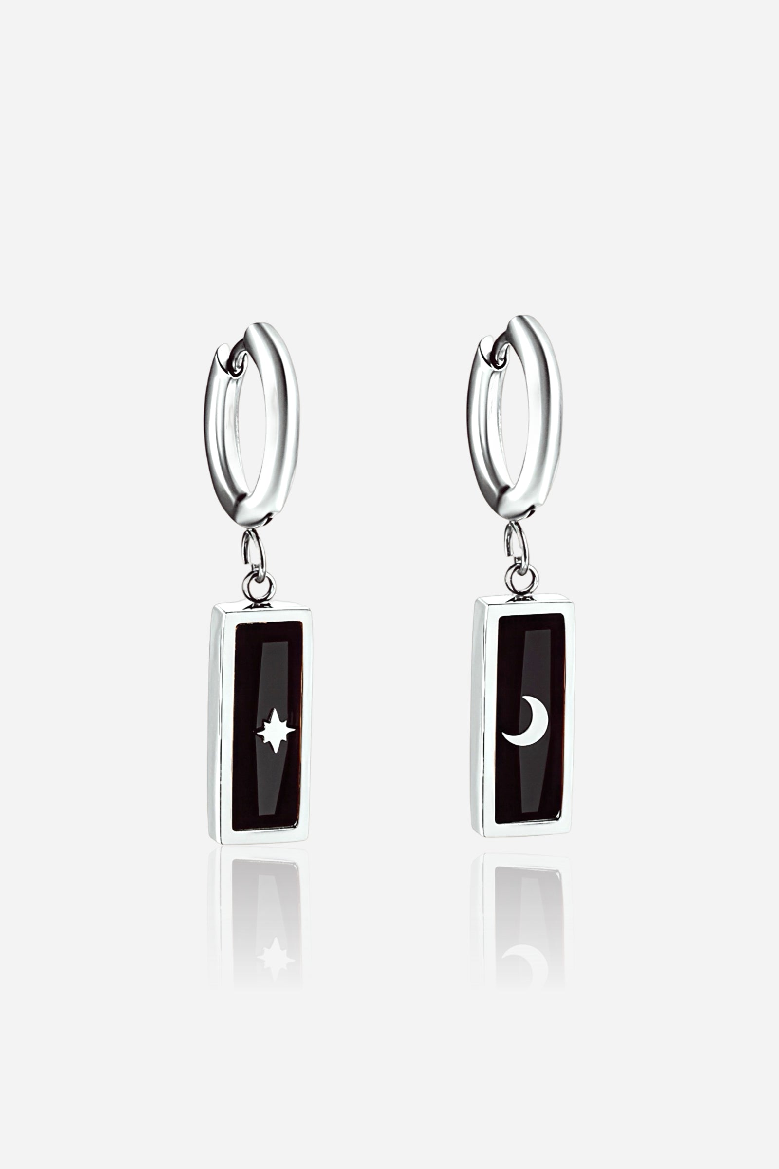 Front view of Moon & Star black enamel drop earrings crafted from polished stainless steel in silver tone, featuring celestial motifs – GLISTIA.
