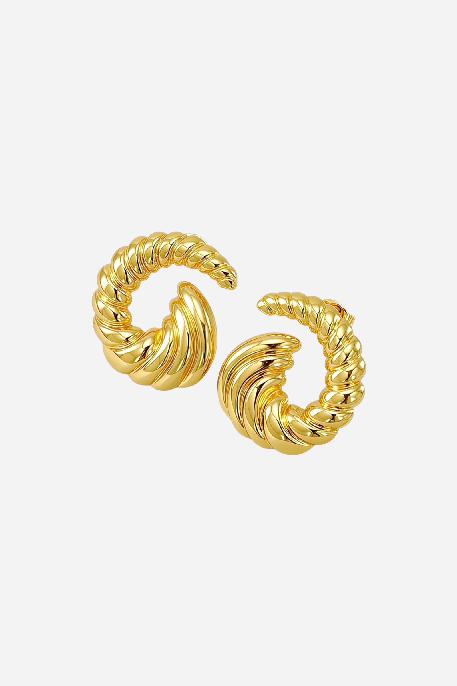 Angled view of open spiral swirl stud earrings crafted from stainless steel with a radiant PVD 18K gold plated finish, showcasing the curved twisted texture – GLISTIA.
