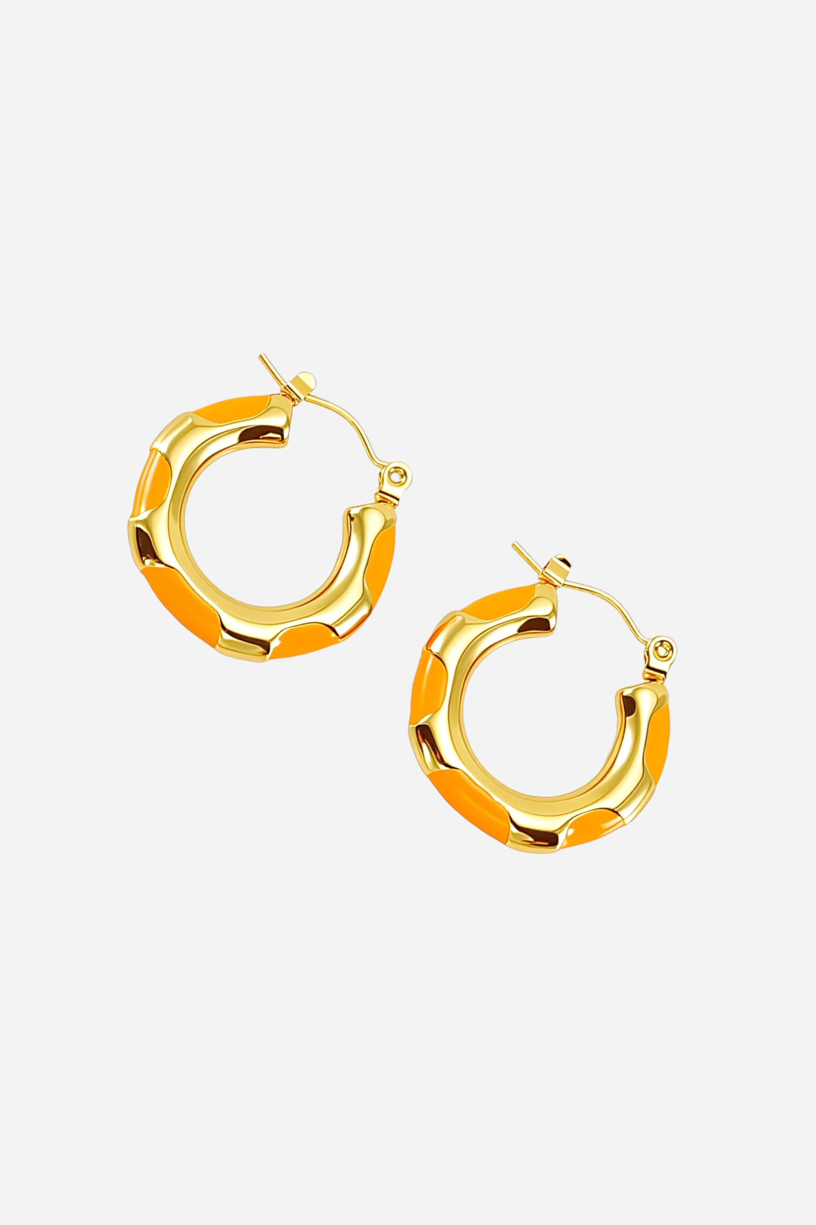 Angle view of orange bamboo hoop earrings crafted from stainless steel with a polished 18K gold plated finish and orange enamel accents – GLISTIA.