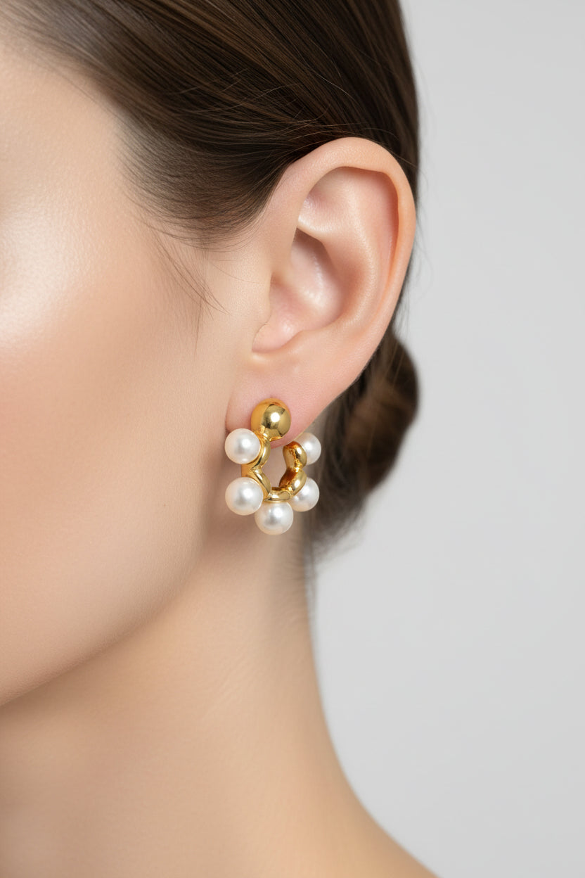 Pearl cluster hoop earrings in 18K PVD gold plated stainless steel with polished finish, worn on ear