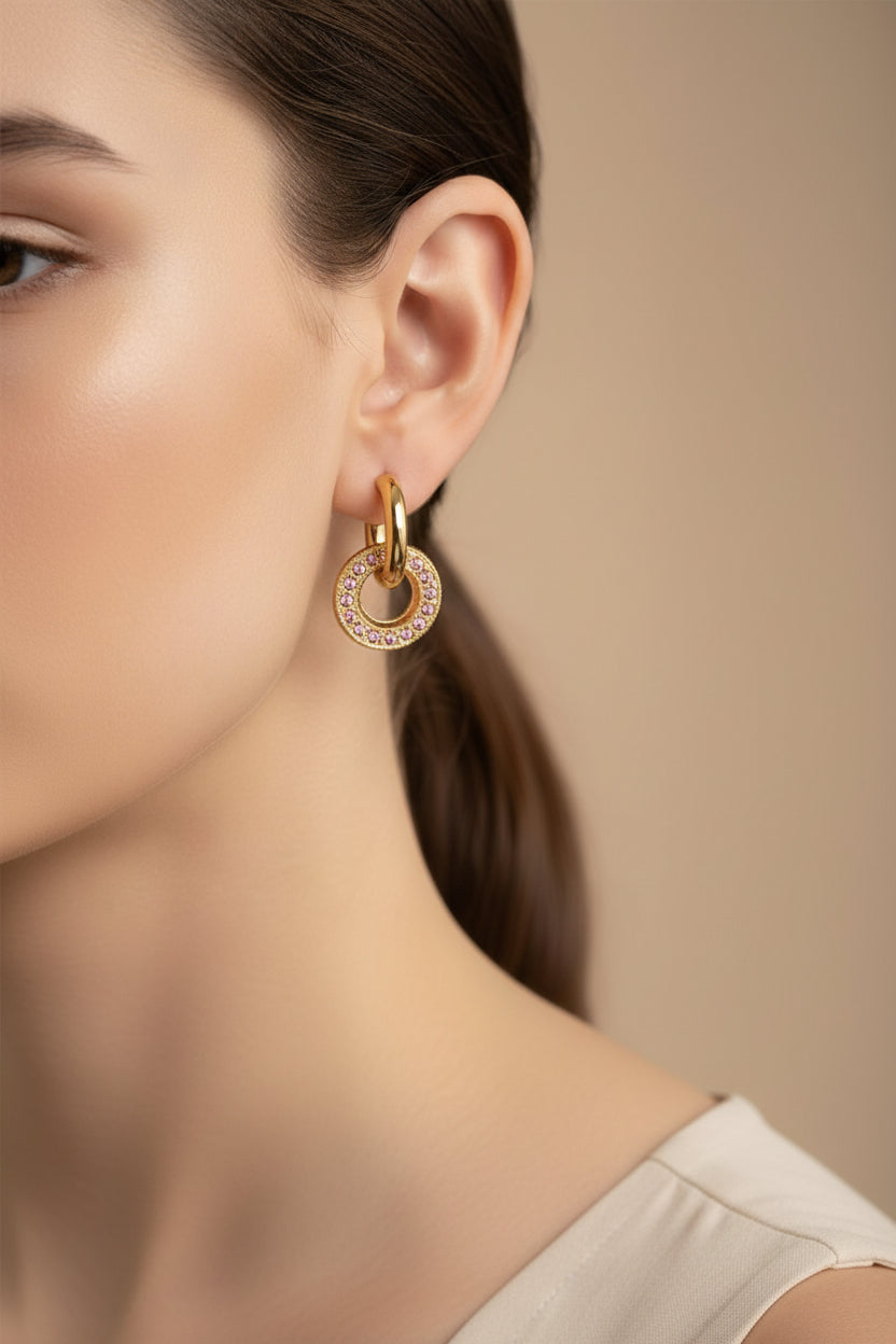 Pink crystal circle hoop earrings crafted from stainless steel with 18K PVD gold plating, featuring circular drop accents with sparkling pink crystals