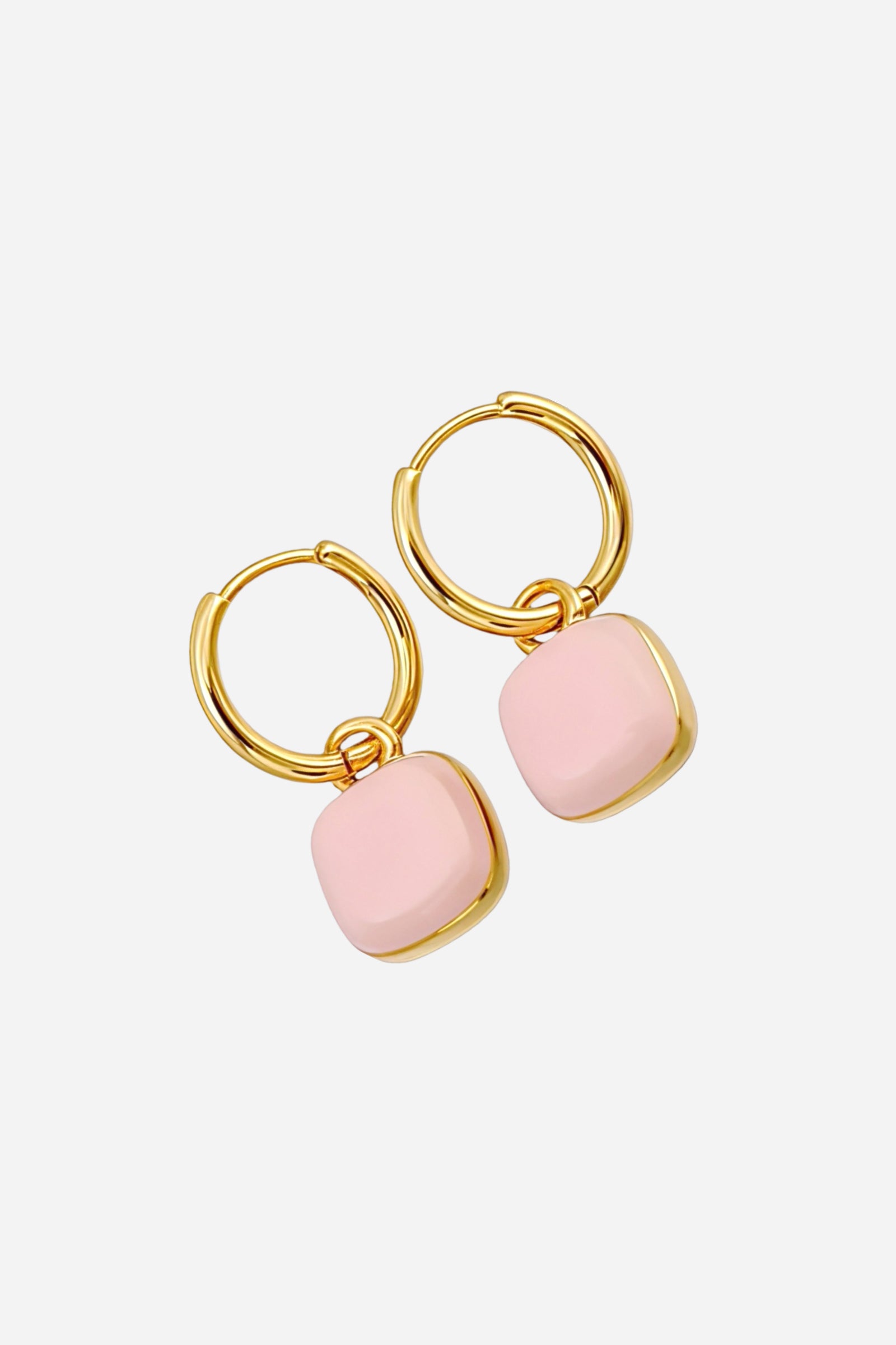 Close-up of pink square charm drop hoop earrings in stainless steel with a radiant PVD 18K gold plated finish, featuring soft blush enamel charms - GLISTIA.