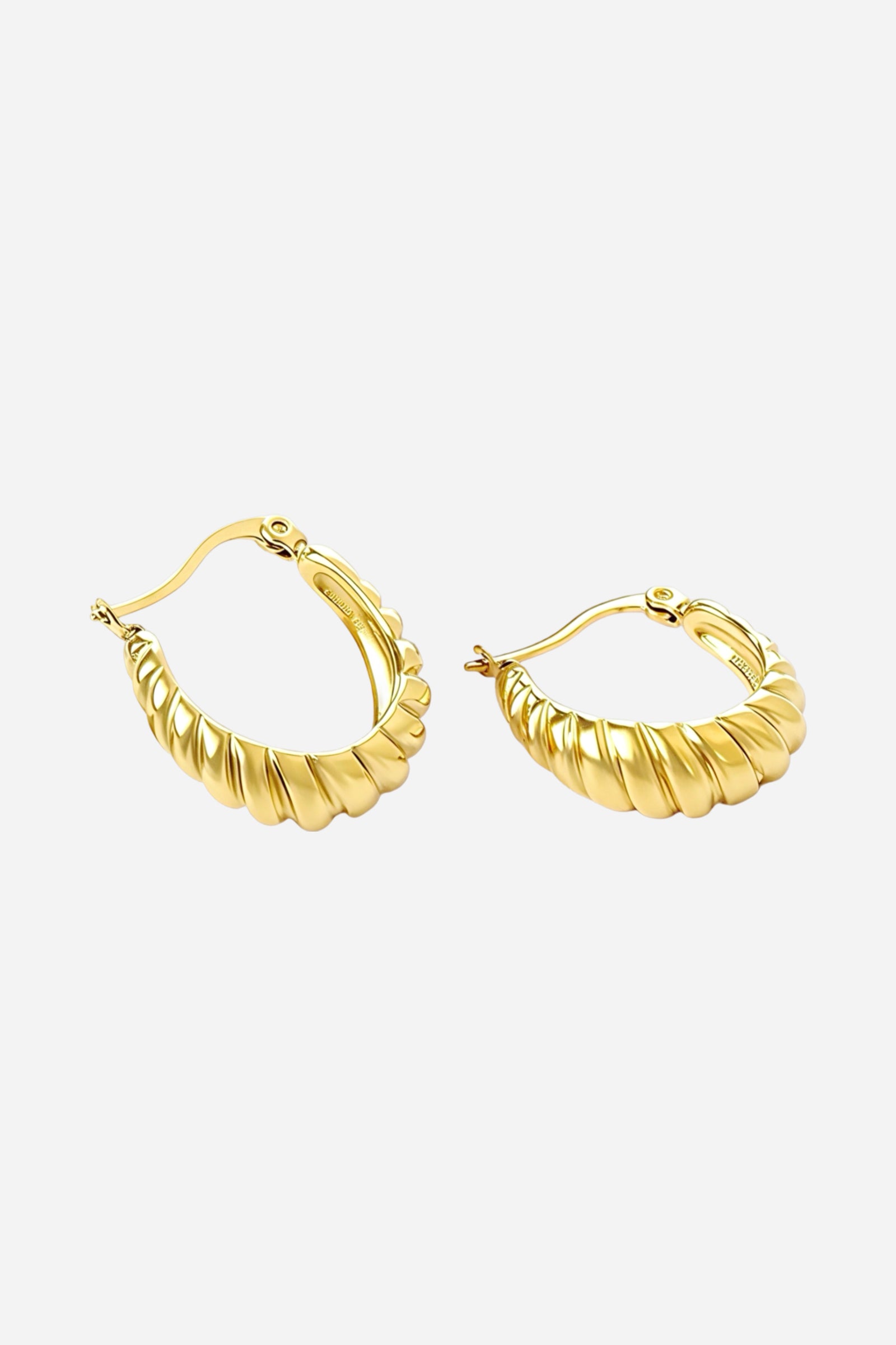Ribbed gold hoop earrings in 18K PVD gold plated stainless steel, shown from top angle highlighting the curved sculptural texture and polished finish — GLISTIA jewellery