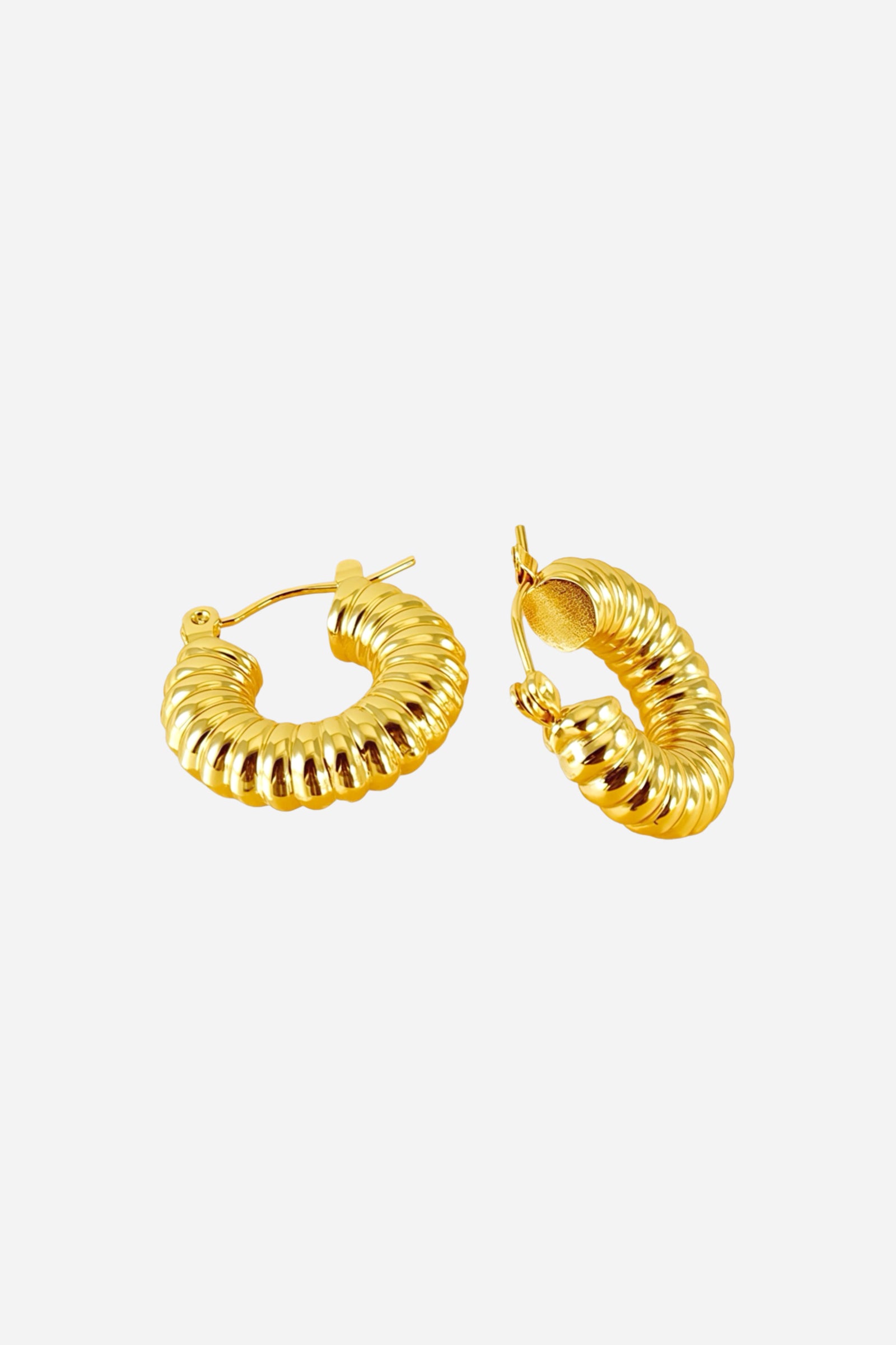 Top view of ribbed textured hoop earrings crafted from stainless steel with a lustrous PVD 18K gold plated finish, featuring sculpted ridges and a curved hoop silhouette – GLISTIA.