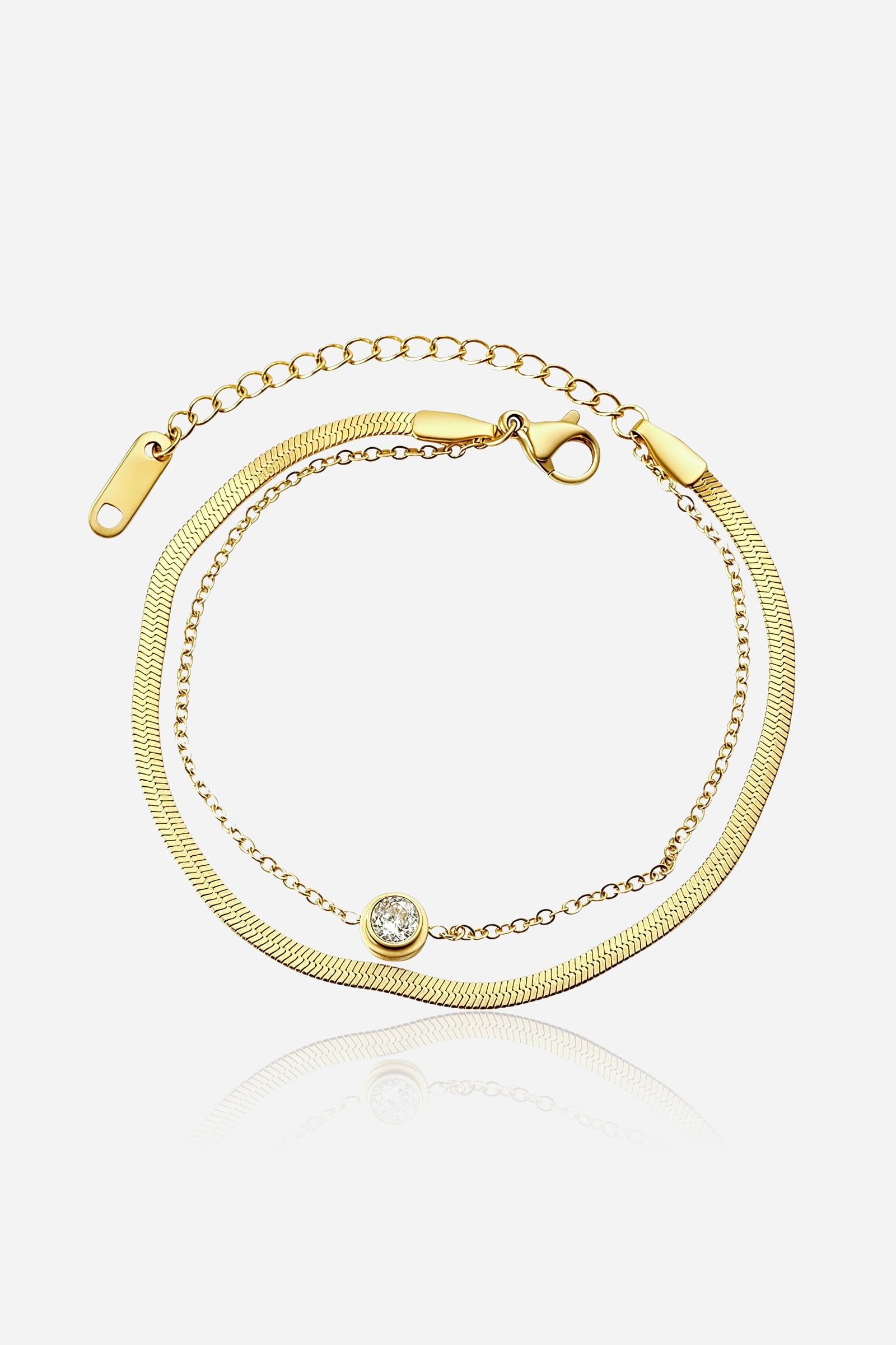 GLISTIA Serena dual chain crystal bracelet in PVD 18K gold plated stainless steel shown from the front with a bezel-set round crystal.