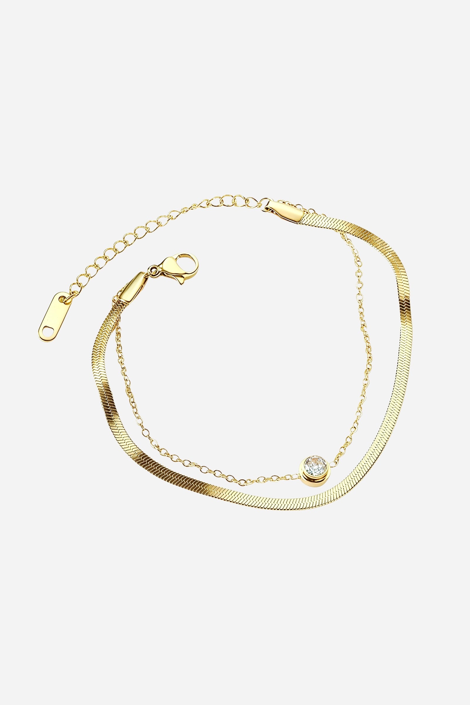 Side-angle view of the GLISTIA Serena dual chain bracelet highlighting the polished gold finish and sparkling crystal centre.