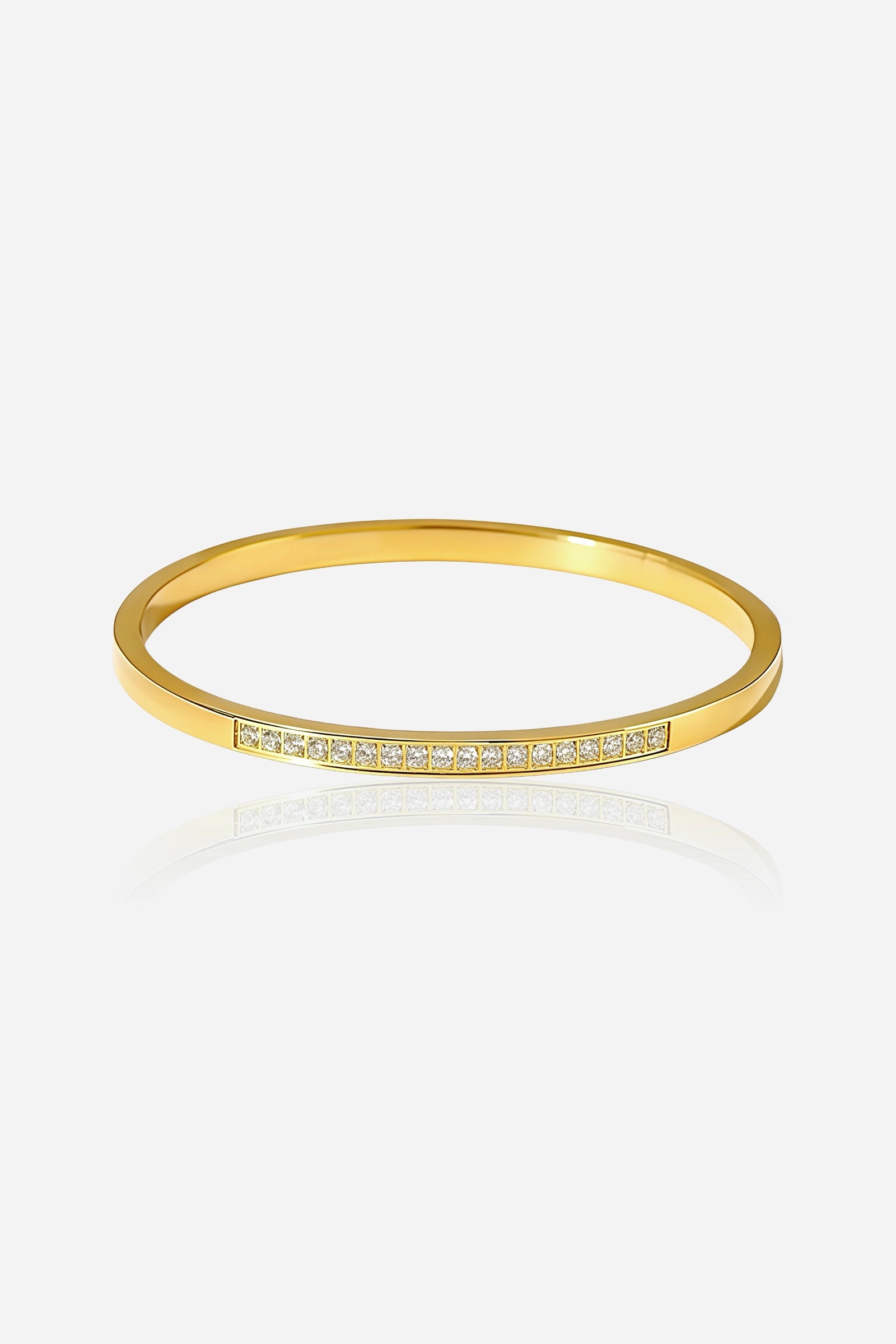 Front view of the Slim Crystal Bar Bangle made from polished stainless steel with 18K PVD gold plating, featuring a line of clear cubic zirconia stones - GLISTIA.