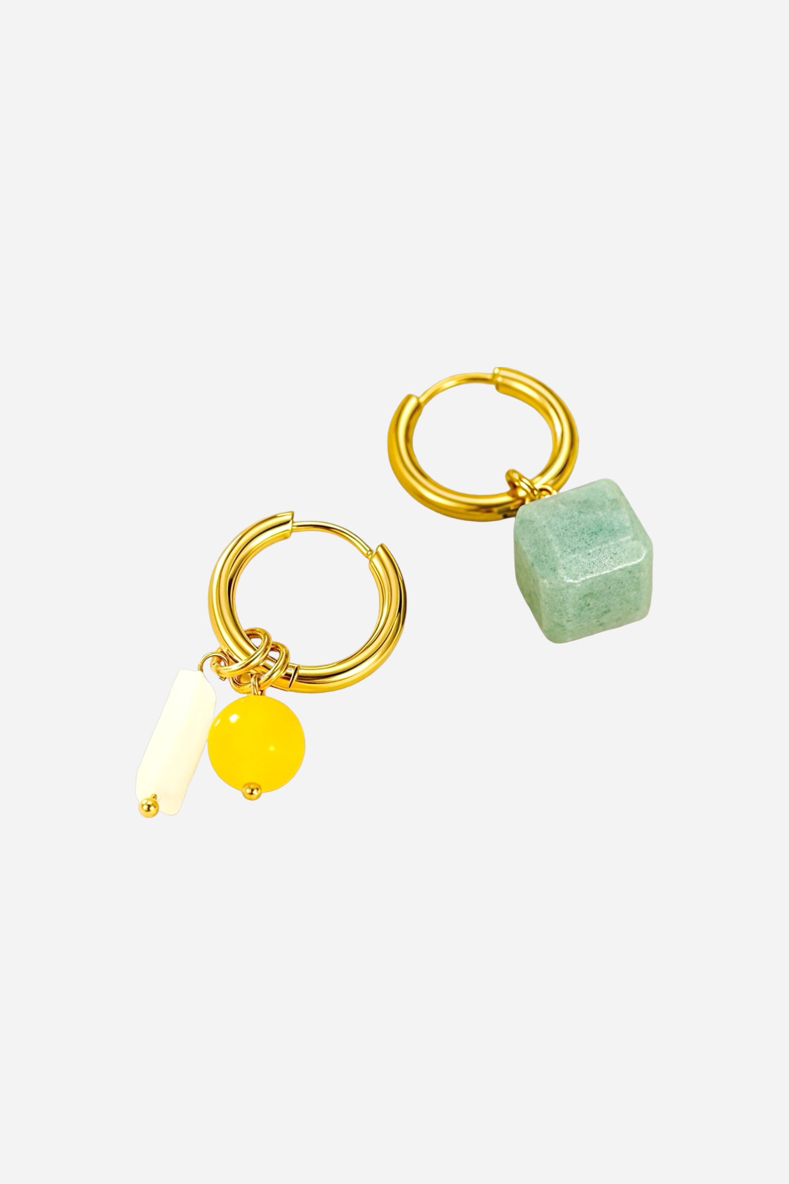 Angled view of Solara charm hoop drop earrings crafted from stainless steel with a radiant 18K PVD gold plated finish, featuring asymmetrical charms in turquoise, amber, and ivory tones - GLISTIA.