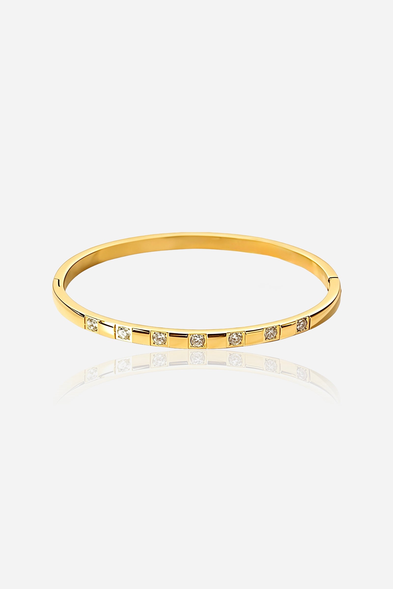 Front view of GLISTIA Spaced Crystal Bangle crafted from stainless steel with PVD 18K gold plating, featuring evenly spaced cubic zirconia accents in a polished finish.