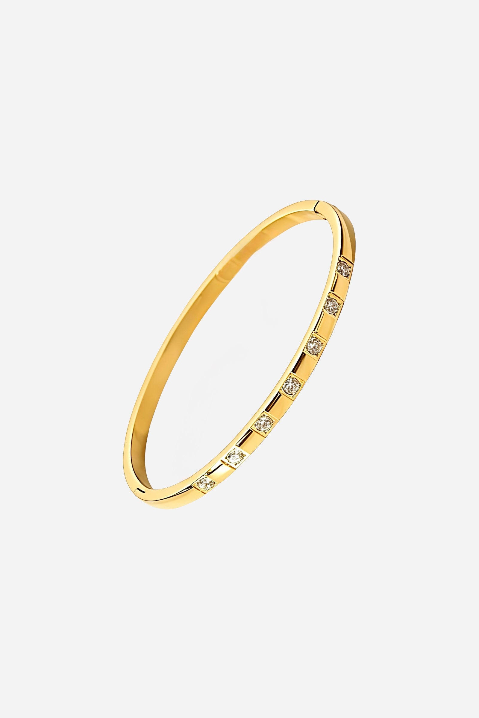 Side profile of GLISTIA gold bangle showing precise alignment of evenly spaced cubic zirconia along the polished 18K PVD surface.