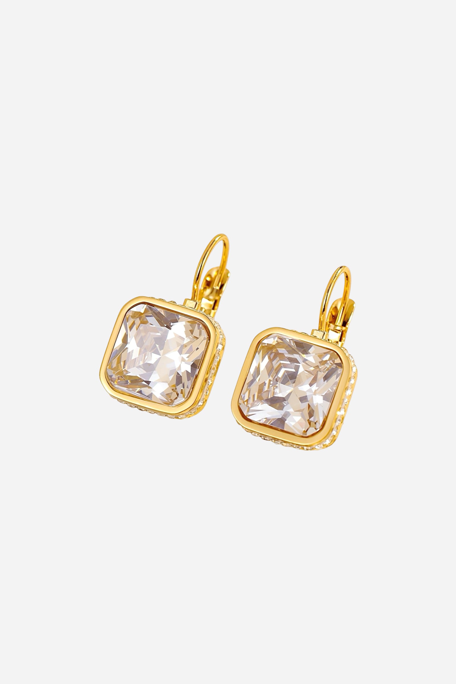 Angled close-up of square crystal drop earrings crafted from stainless steel with a radiant PVD 18K gold plated finish, showcasing faceted cubic-cut crystals in lever-back setting - GLISTIA.