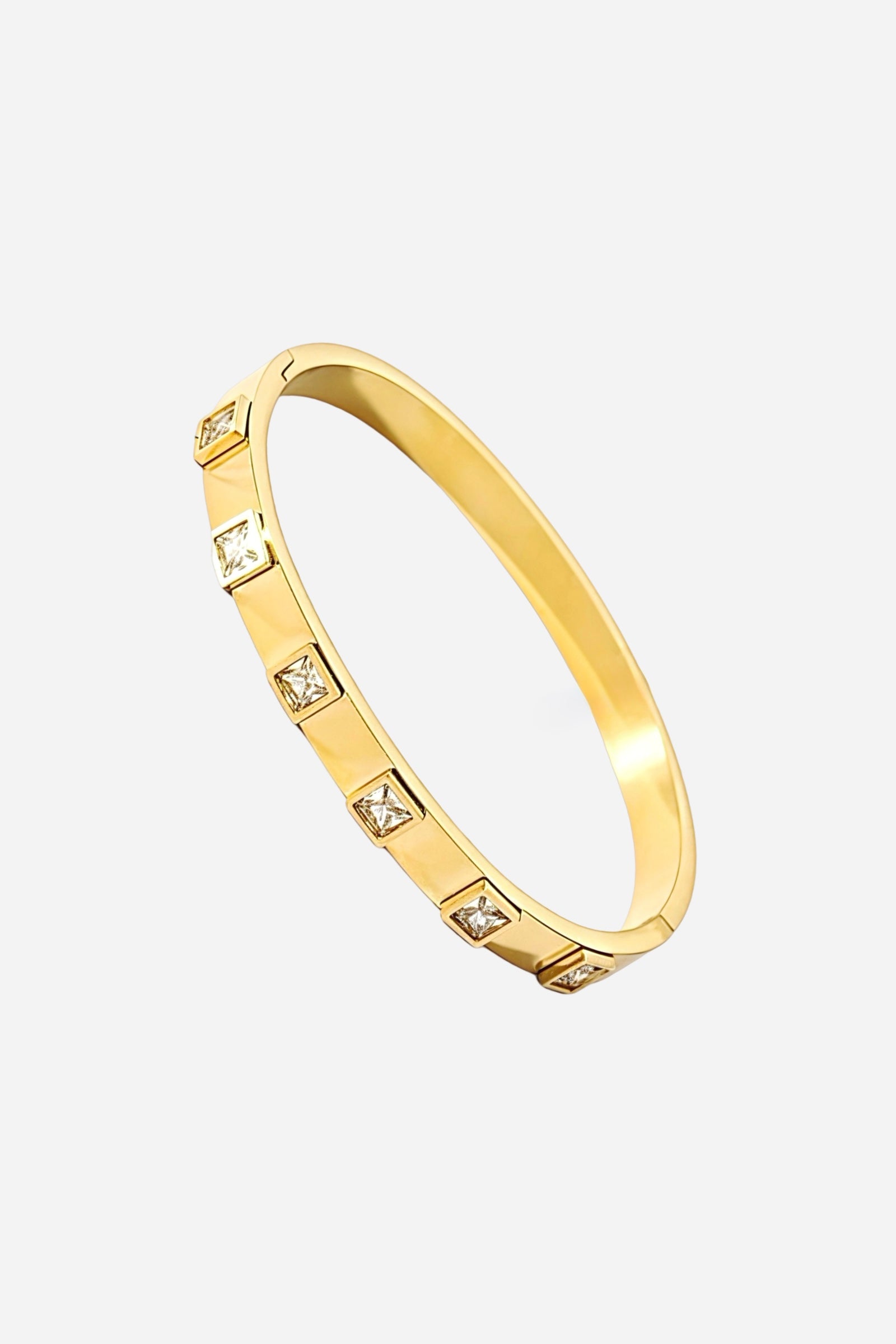 Side angle of the 18K gold-plated stainless steel bangle showing its slim form and precise square-cut crystal settings - GLISTIA.