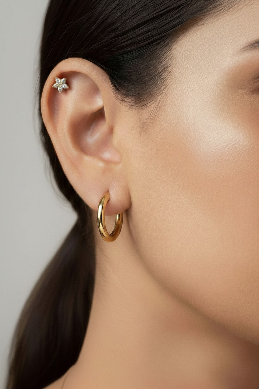 Star crystal flat-back piercing earring crafted from stainless steel with 18K PVD gold plating, featuring a five-point star design set with cubic zirconia