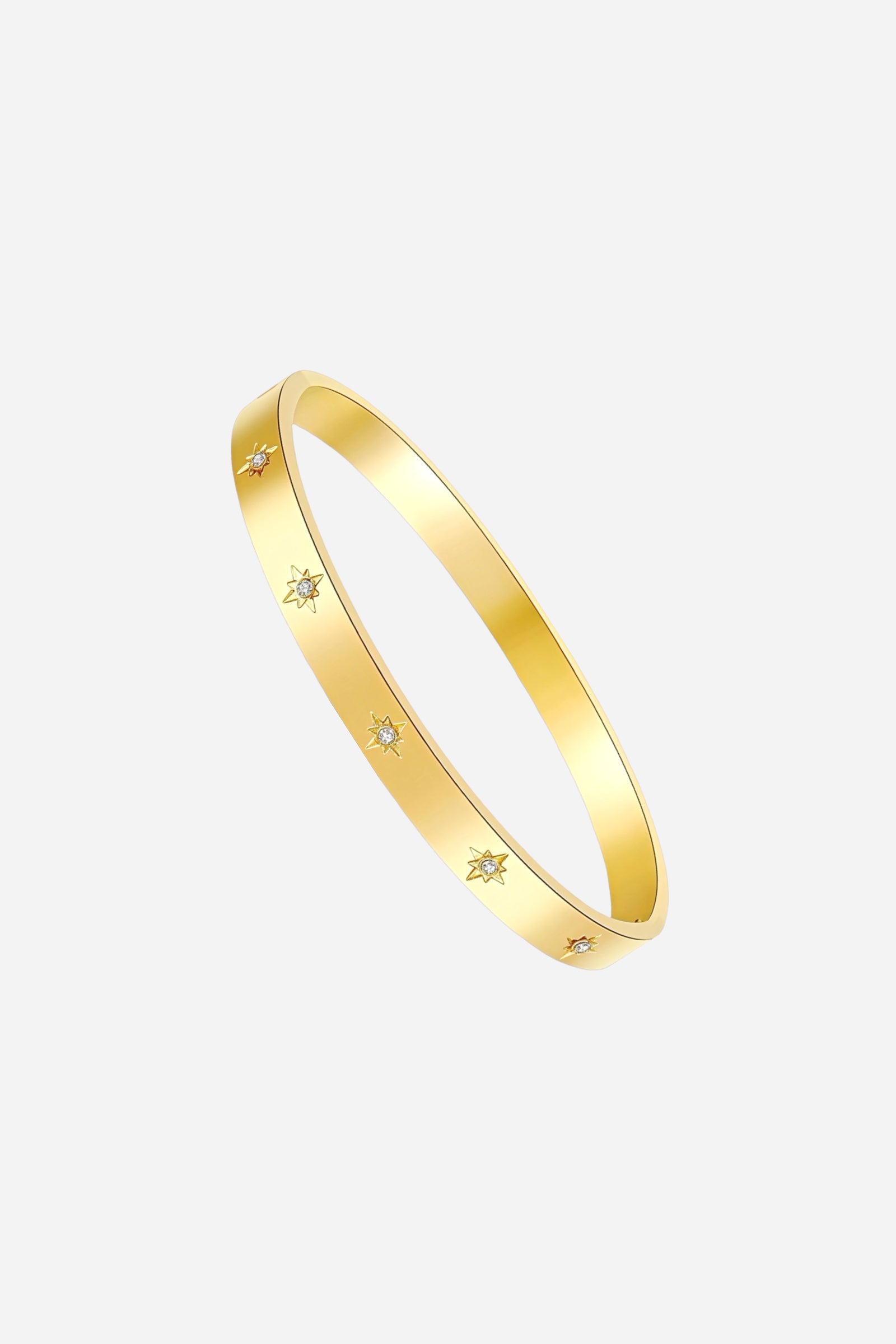 Side profile of GLISTIA 18K gold plated Starburst Engraved Crystal Bangle showing the slim, curved form and precise cubic zirconia star etchings.