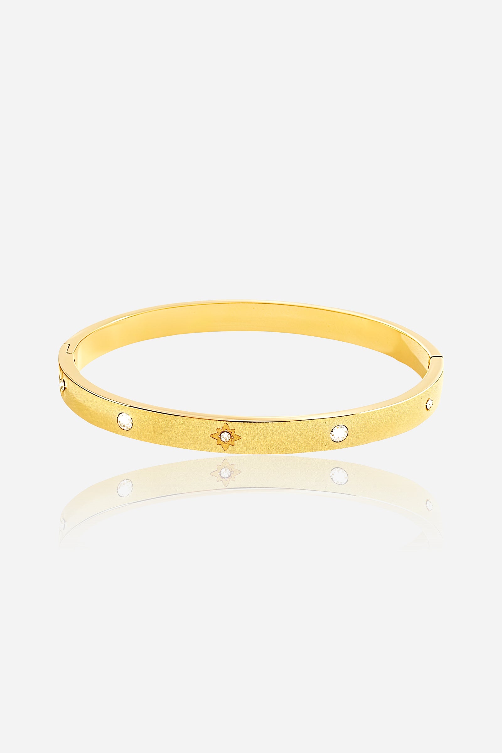 Front view of Stardust Crystal Bangle crafted from stainless steel with a polished 18K PVD gold plated finish, featuring engraved star motifs and cubic-zirconia crystals - GLISTIA