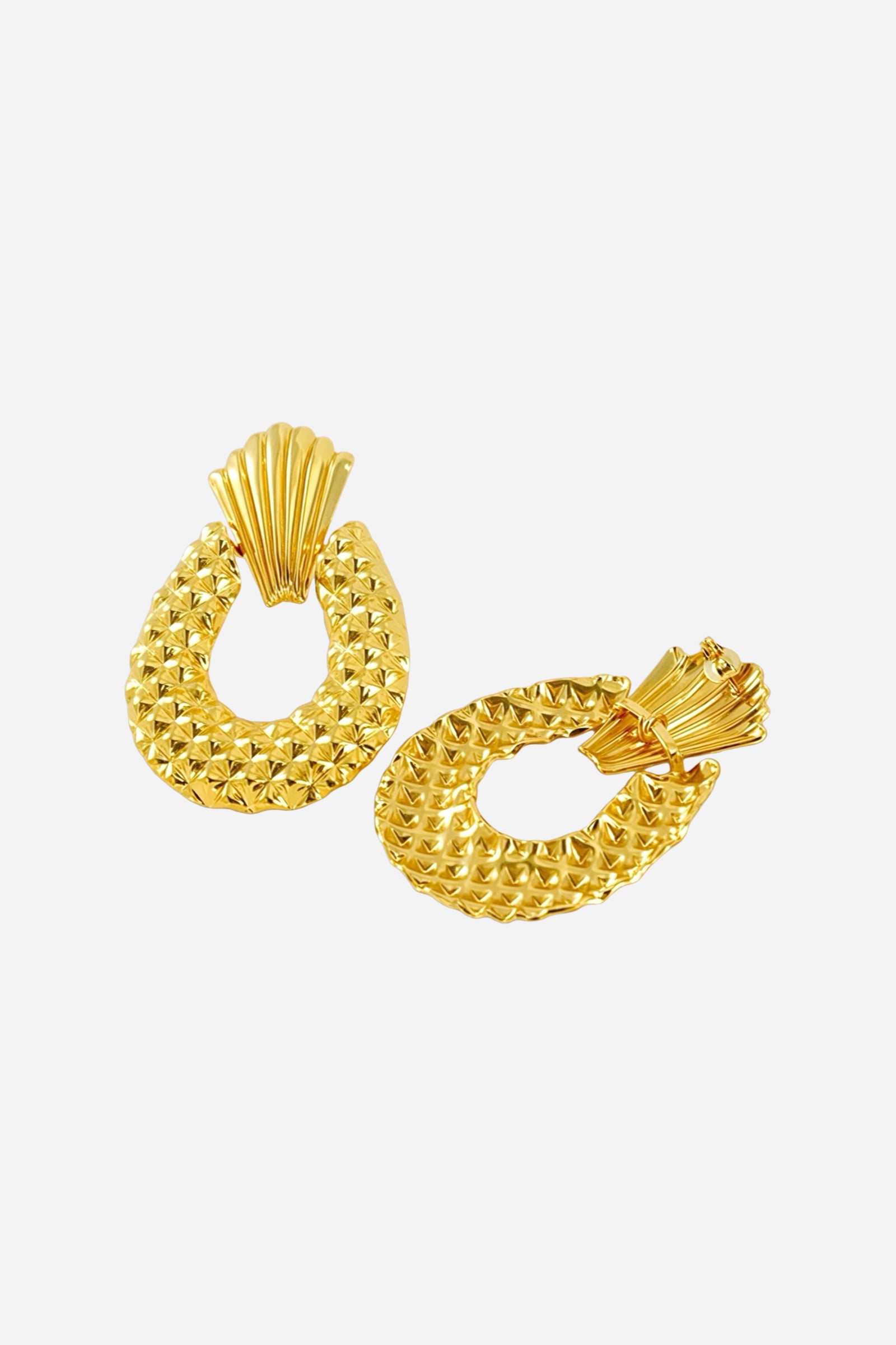 Angled view of textured drop statement earrings crafted from stainless steel with a radiant PVD 18K gold plated finish, featuring a fan-shaped top and intricate geometric texture – GLISTIA.
