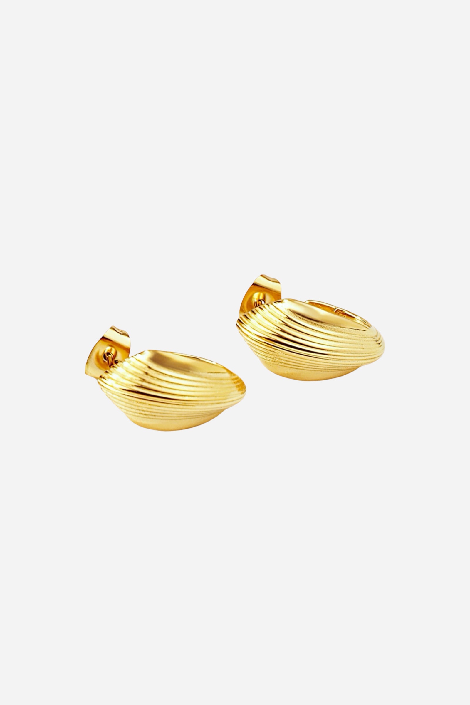 Close-up of textured oval half-hoop stud earrings crafted from stainless steel with a radiant PVD 18K gold plated finish, featuring ribbed detailing and a contoured oval shape for a bold, elegant look – GLISTIA.