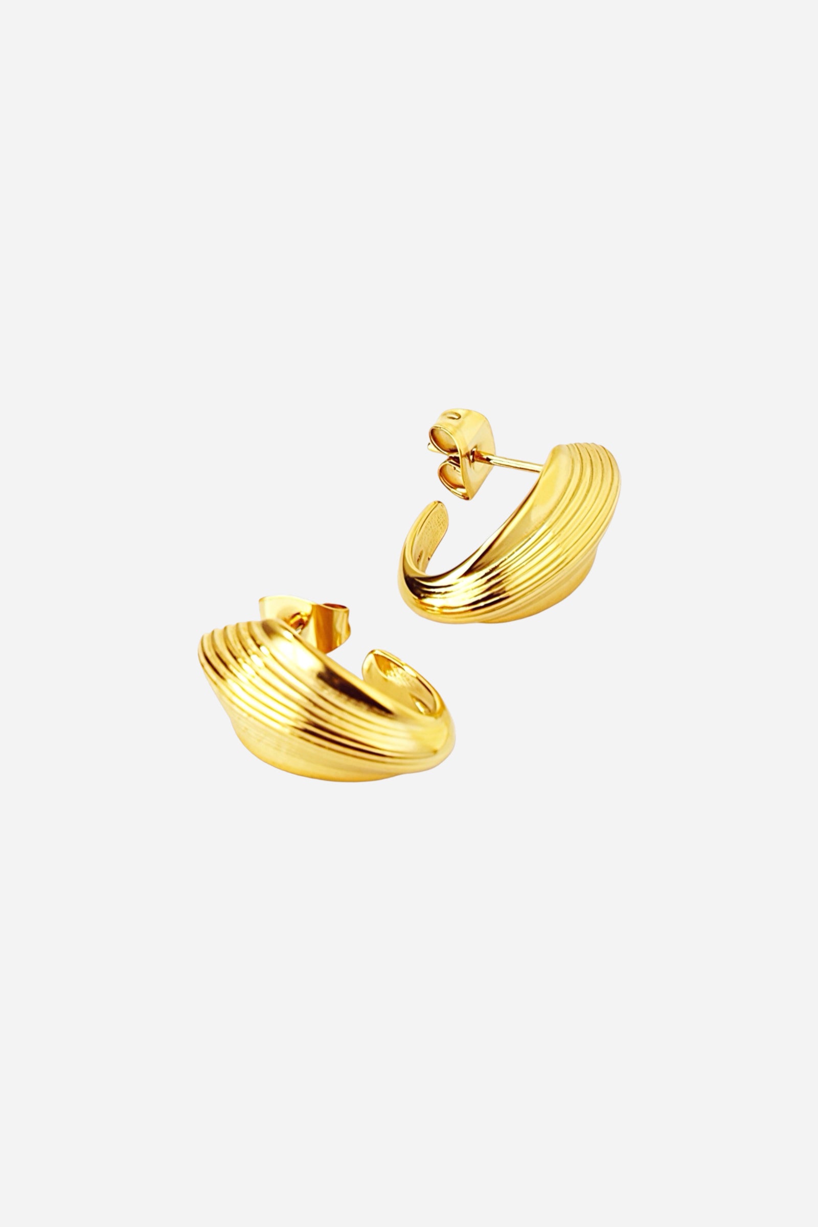 Textured oval half-hoop stud earrings crafted from stainless steel with a sleek PVD 18K gold plated finish, showcasing ribbed detailing and a smooth curved profile for a refined, modern look – GLISTIA.