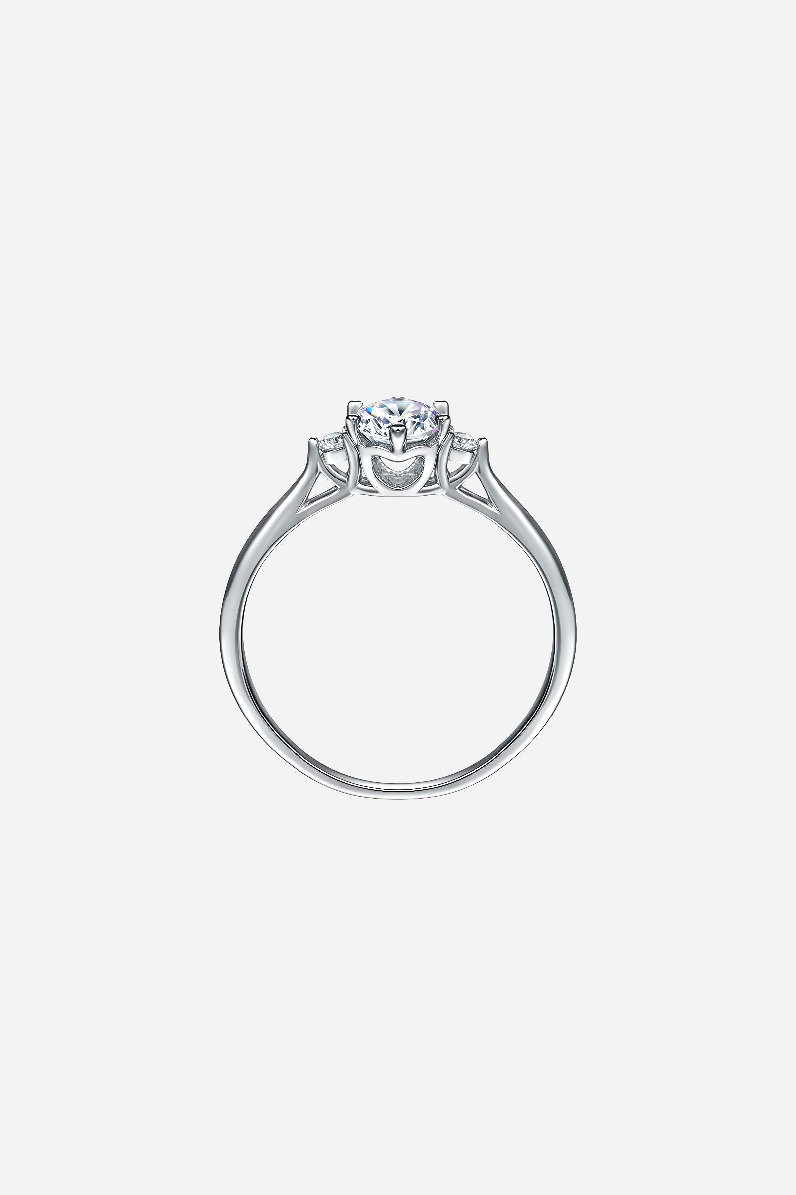 Side-angle image of GLISTIA Three-Stone Round-Cut Zircon Ring showcasing the high-polish mirror finish and elevated prong setting.