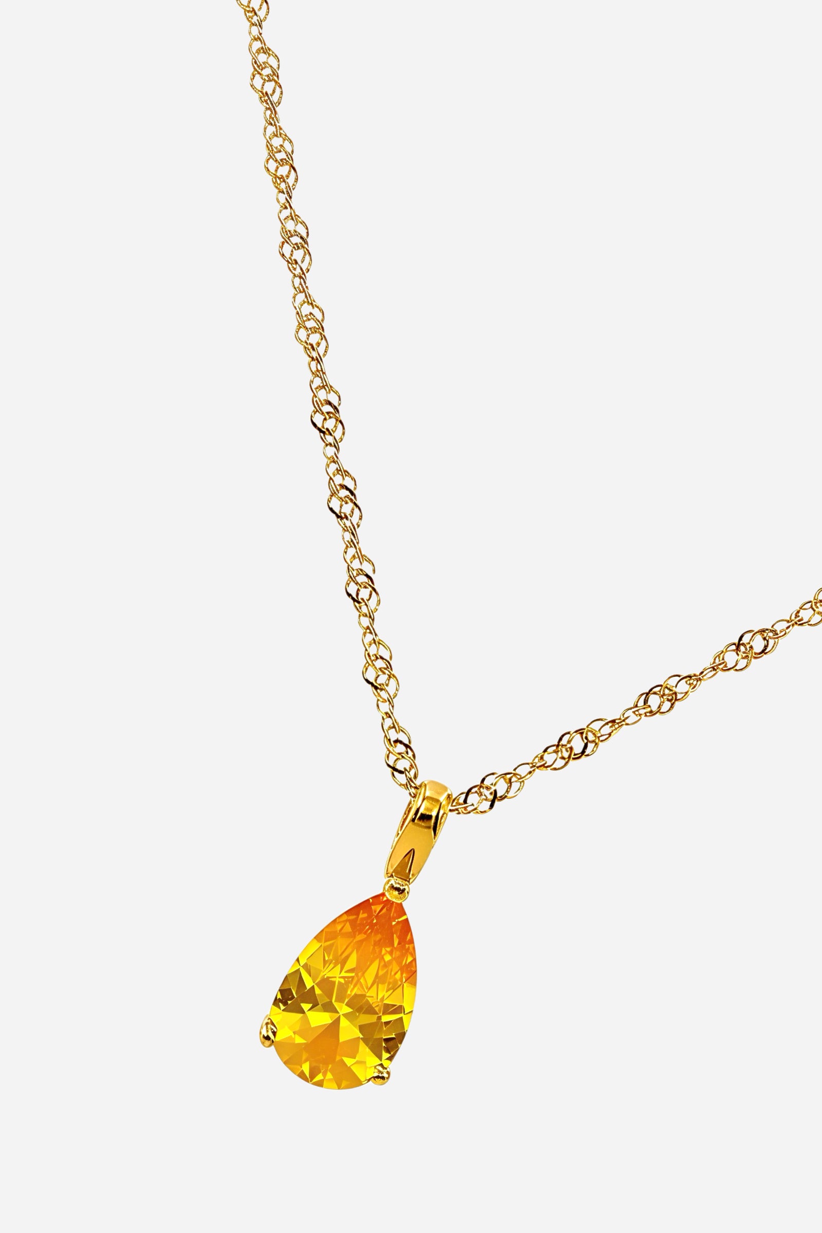 Side angle of Topaz Birthstone Necklace for November with yellow zircon teardrop pendant on gold-plated chain – GLISTIA.