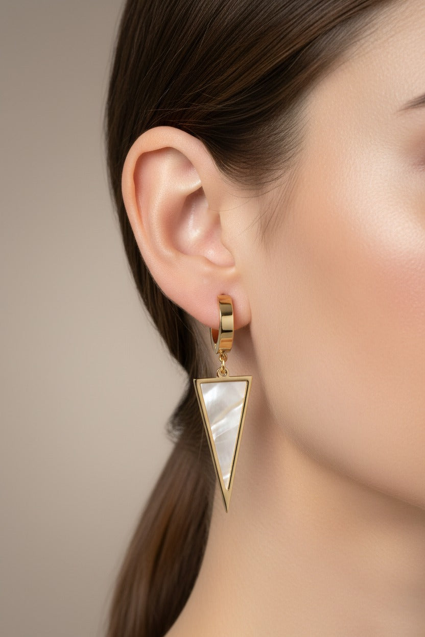 Triangle drop huggie earrings in 18K PVD gold plated stainless steel with pink shell inlay.