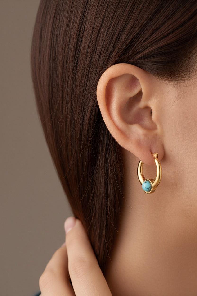 Turquoise stone hoop earrings worn on ear, crafted from stainless steel with 18K PVD gold plating and round turquoise style stone