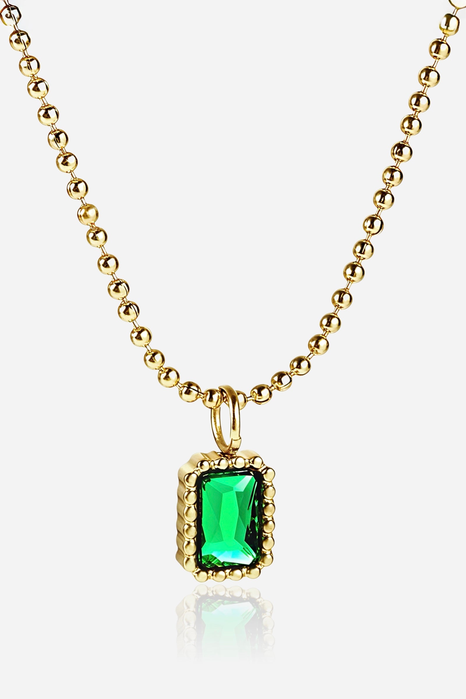 Front view of GLISTIA Verdantia Gem Pendant Necklace with emerald-green rectangular stone in a beaded gold frame.