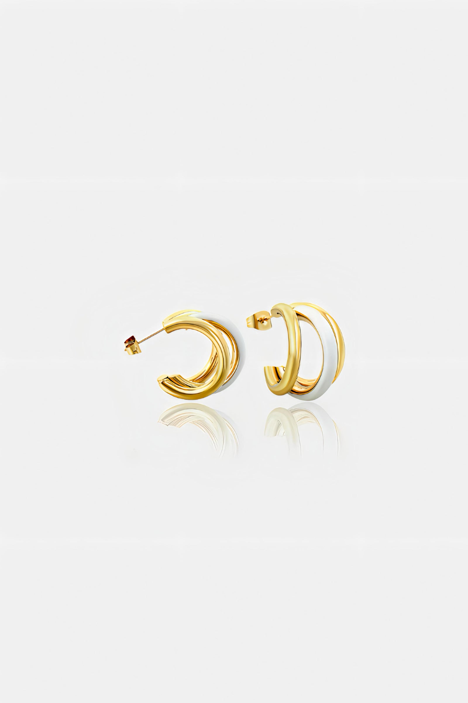 Side view of white and gold double C-hoop earrings in PVD 18K gold plated stainless steel with white enamel – chic contemporary design by GLISTIA