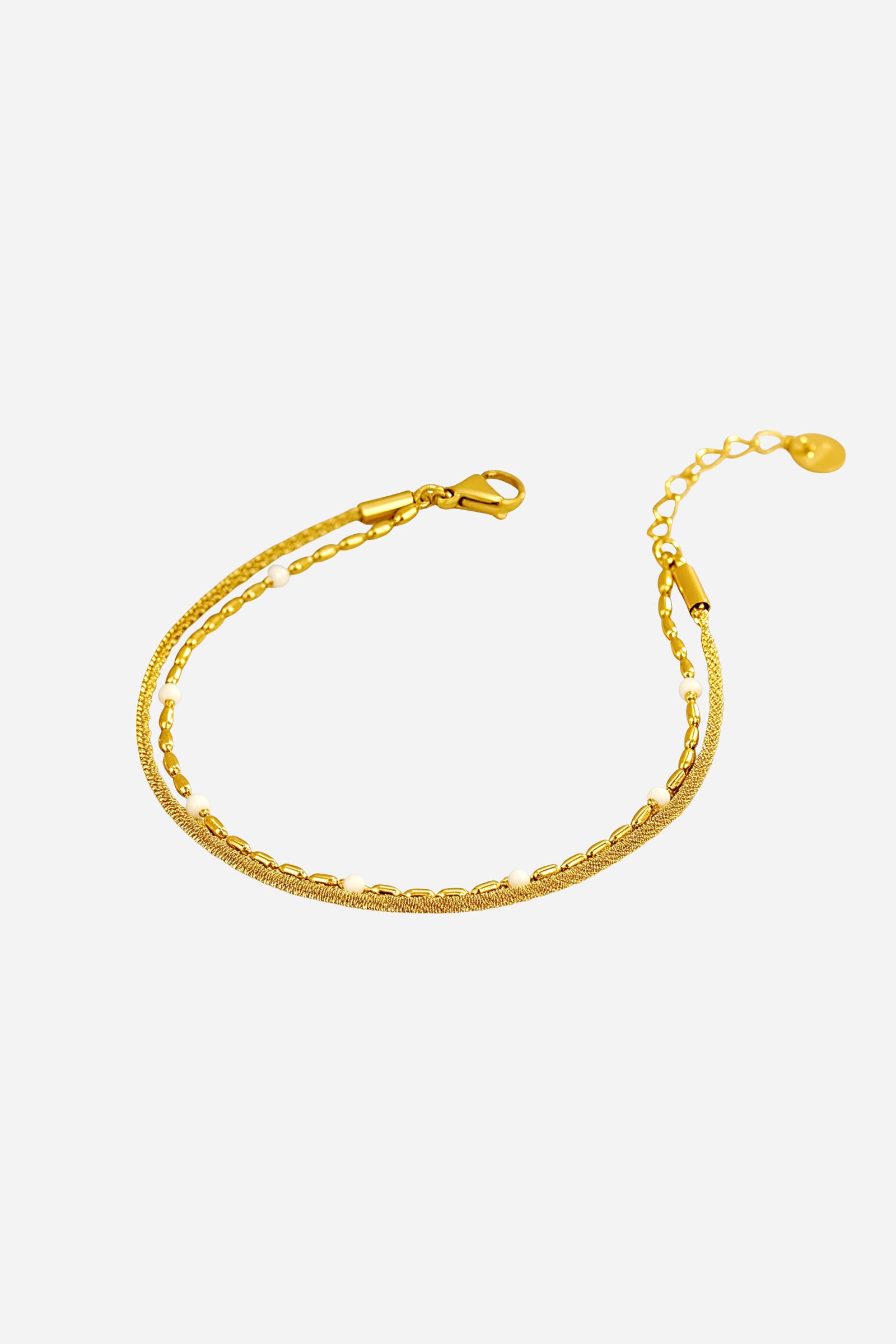 Side view of white beaded dual chain bracelet with gold-toned links and bead accents – Glistia